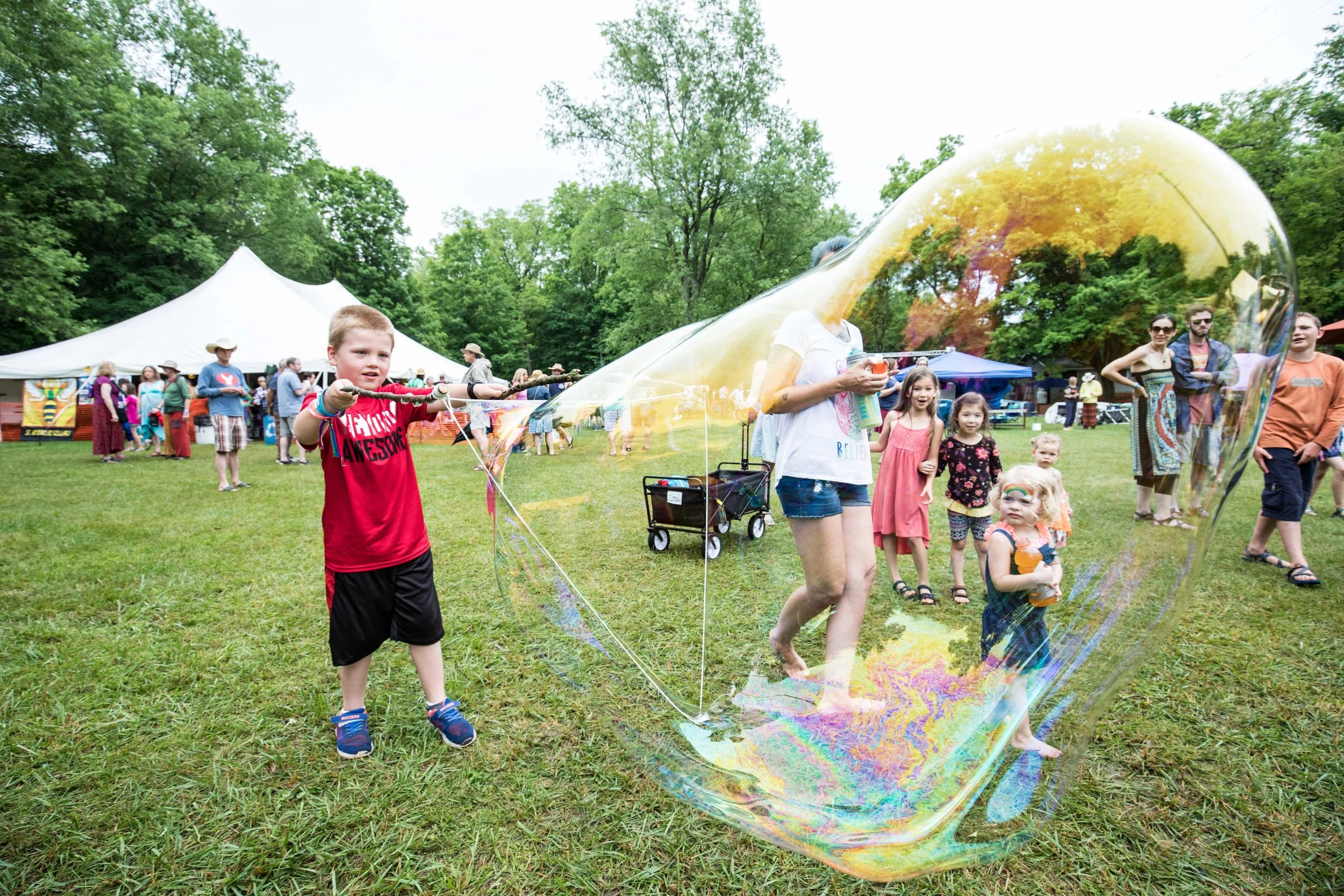 A kid making an enormous bubble