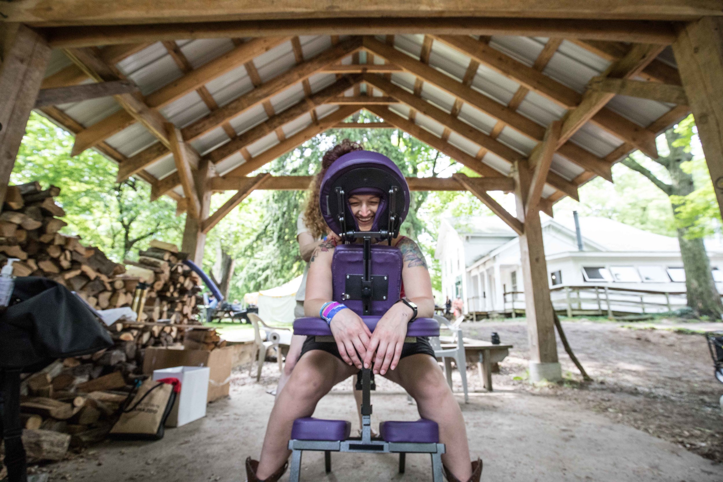  wide angle photo of a festival goer getting a massage  