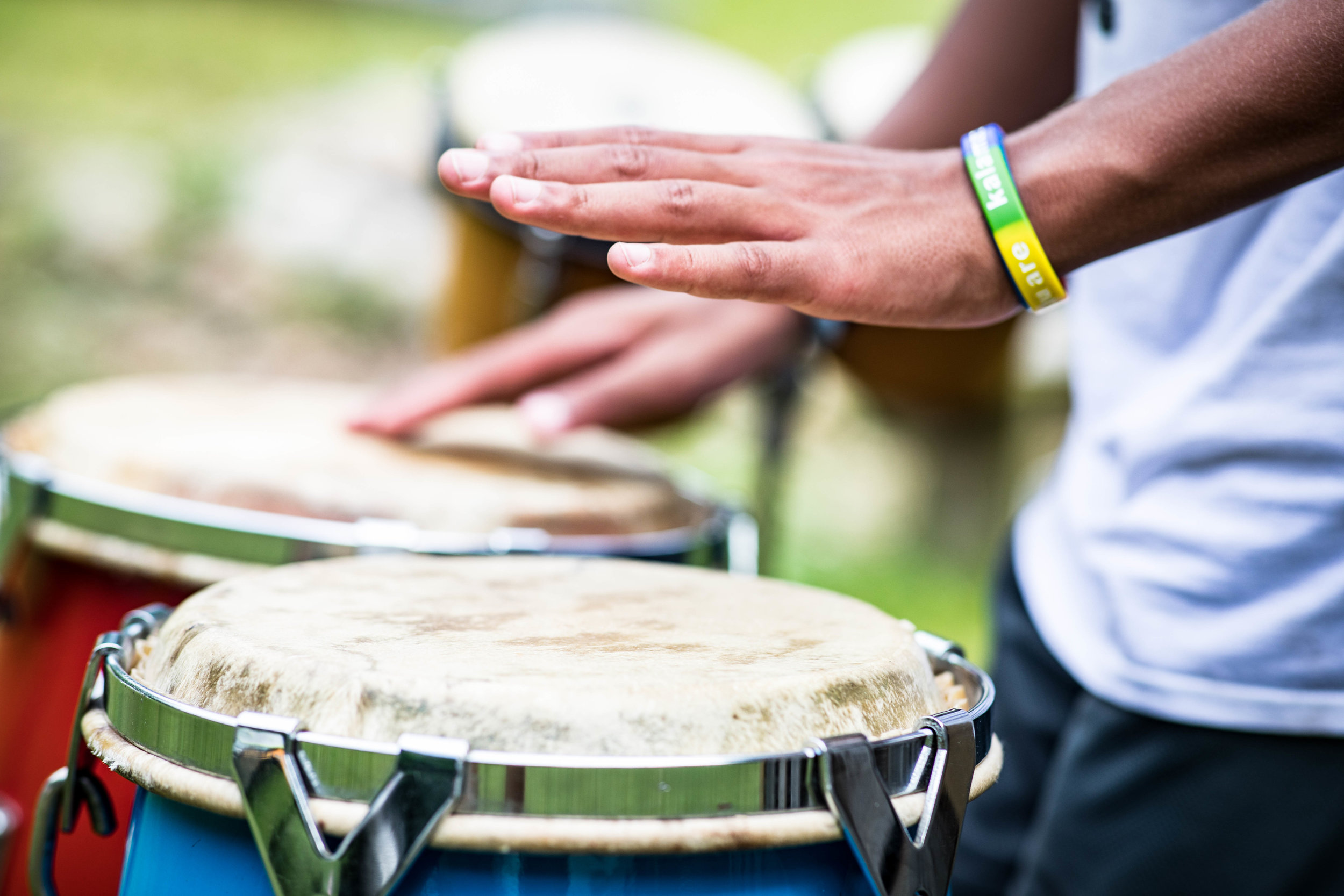  A childs hands playing bongo drums 