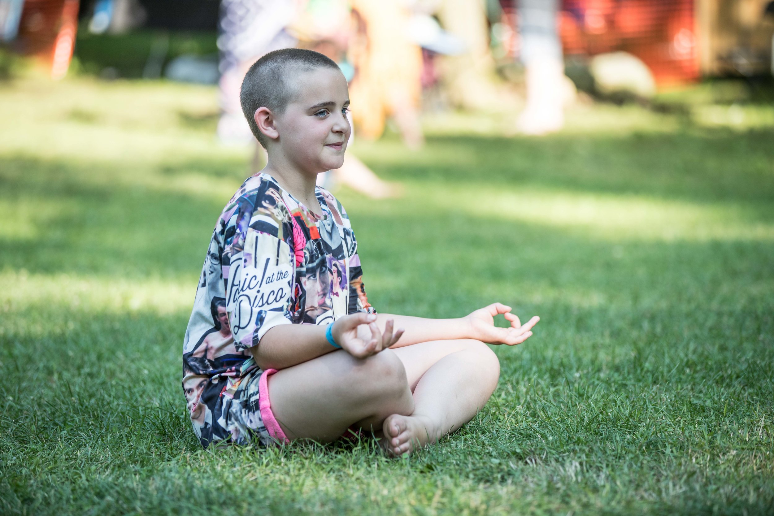  a child meditating in the grass 