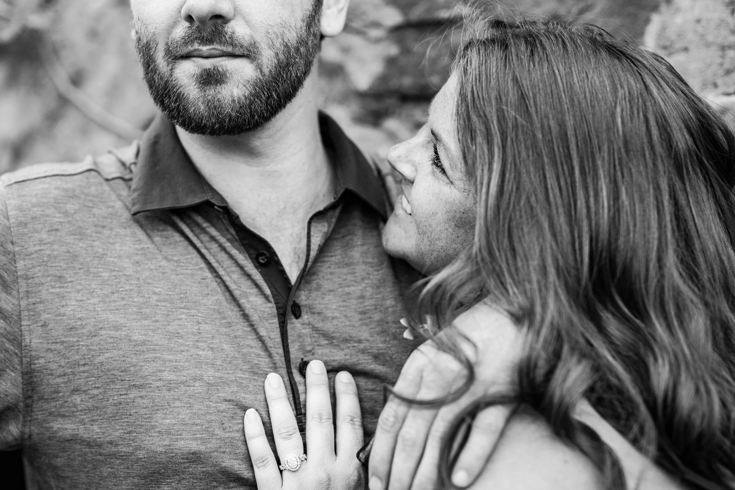 black and white image of a woman looking up at her soon to be husband