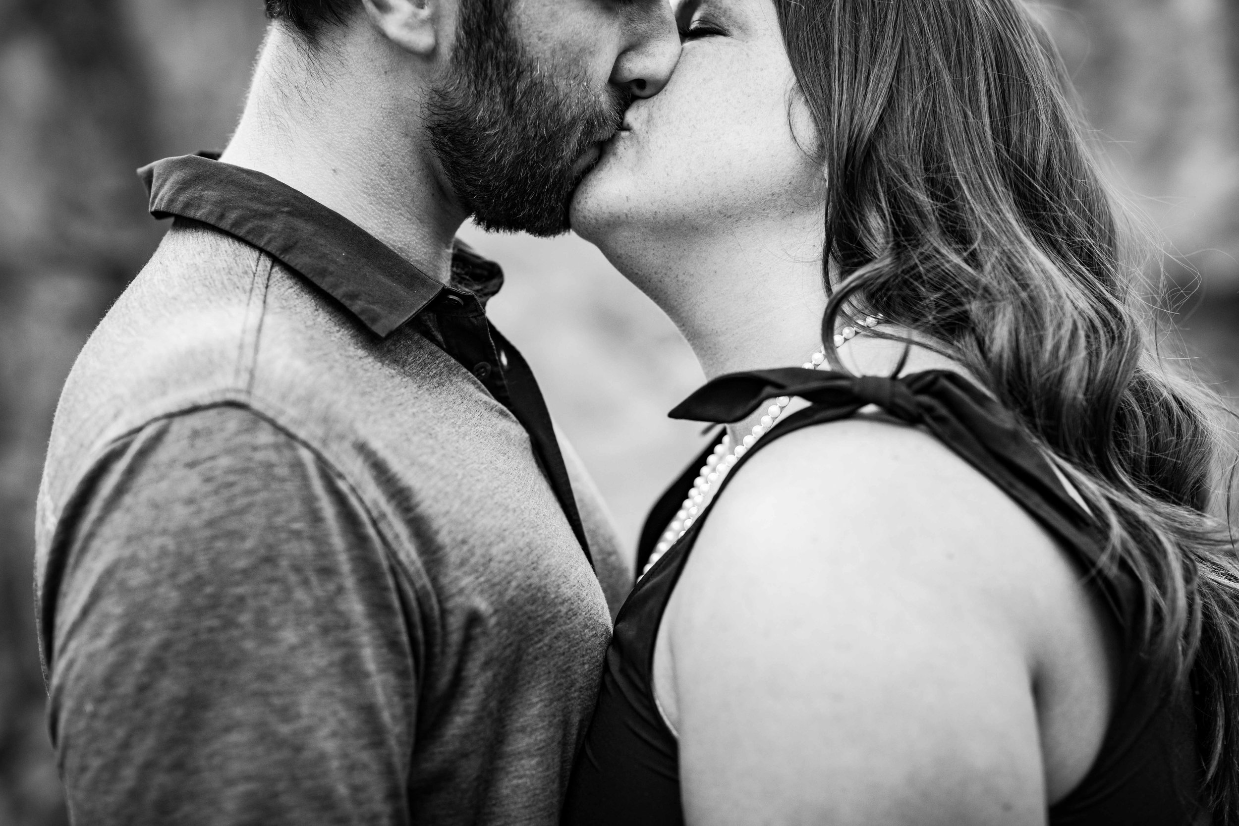  black and white image of man and woman kissing 