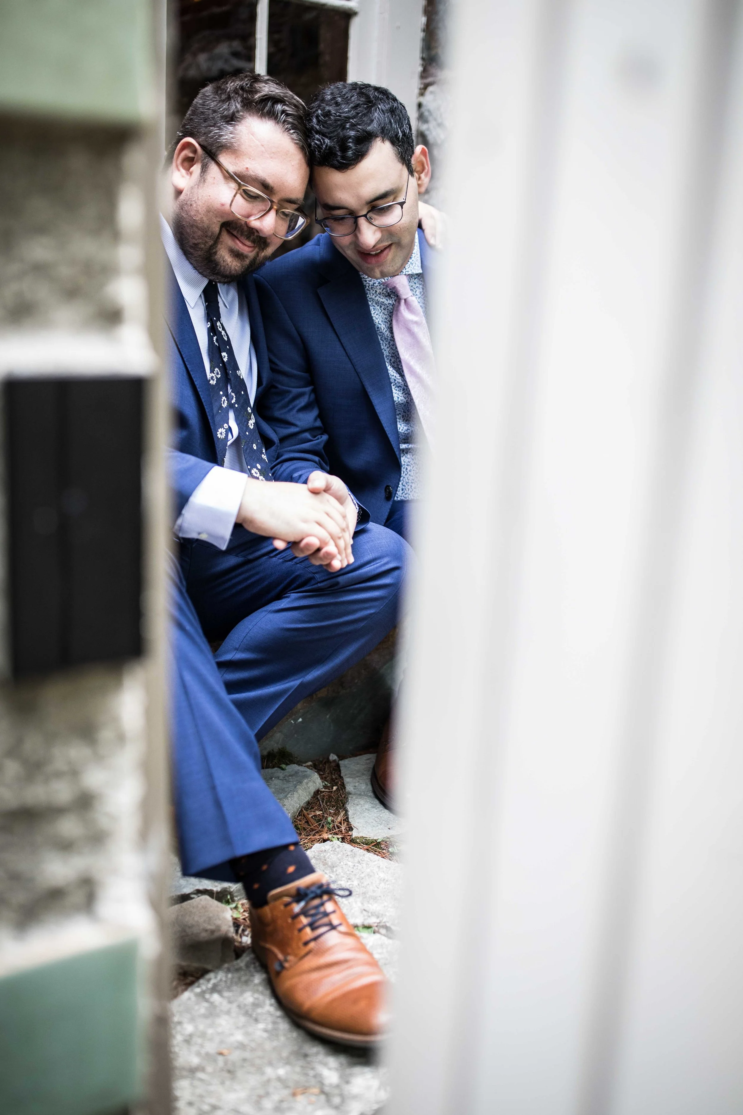 A couple sits secluded, taking a moment to their selves in their final moments before they are married