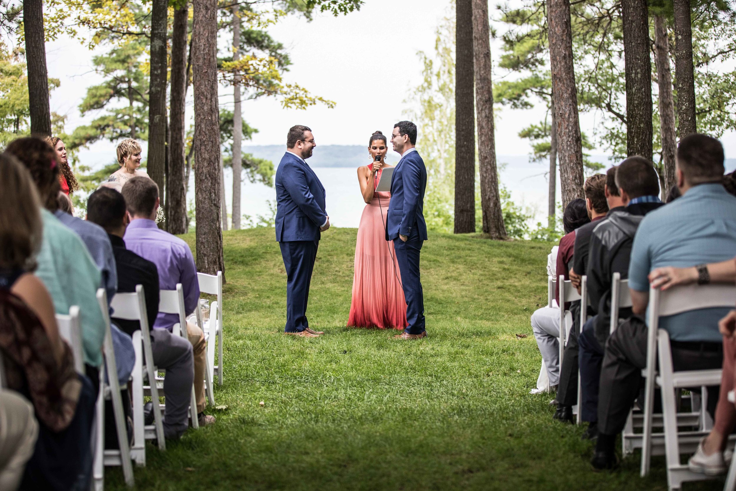  A wedding ceremony for two grooms in front of the Grand Traverse Bay of Lake Michigan 