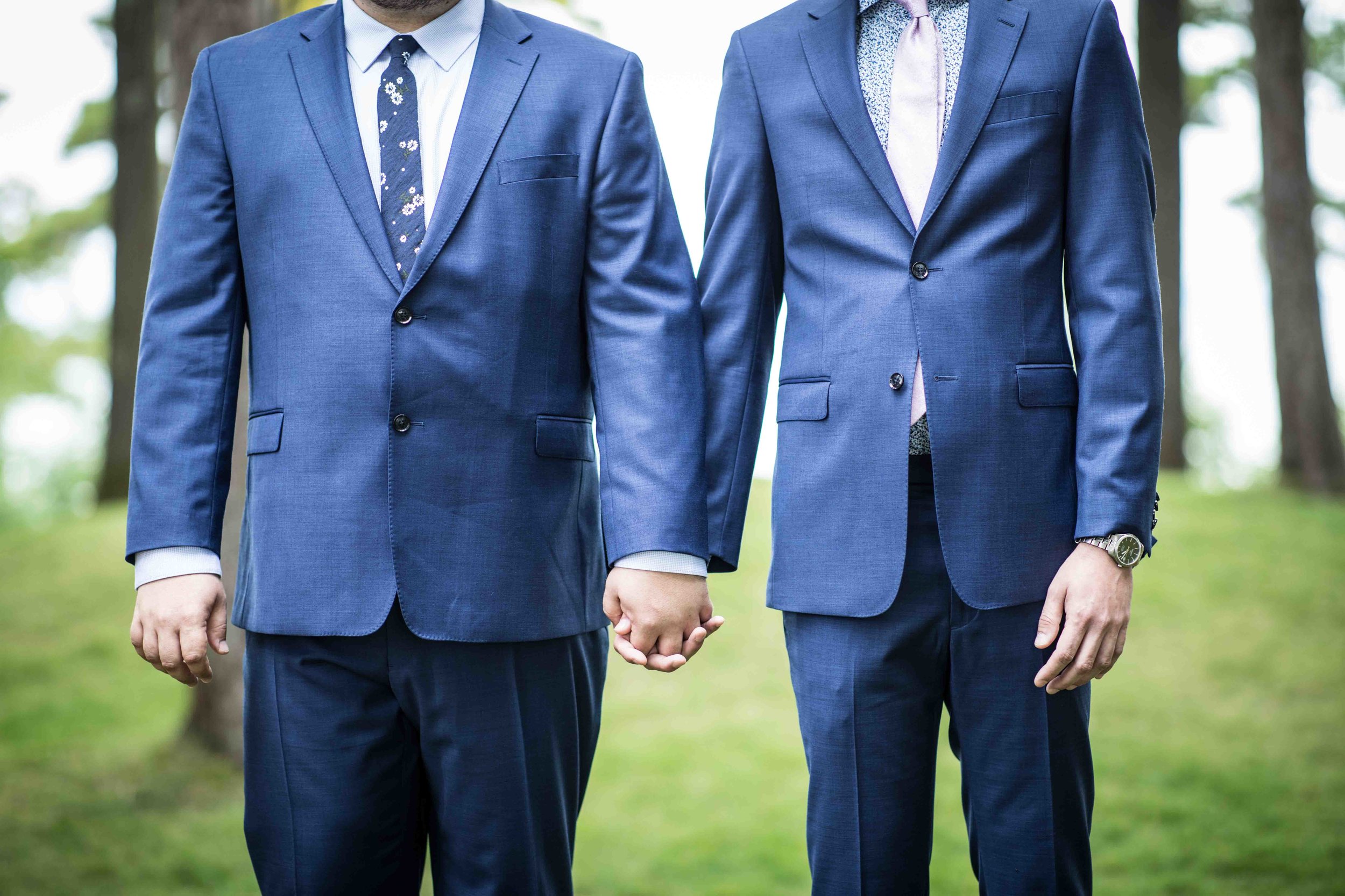  The two grooms hold hands during the ceremony 