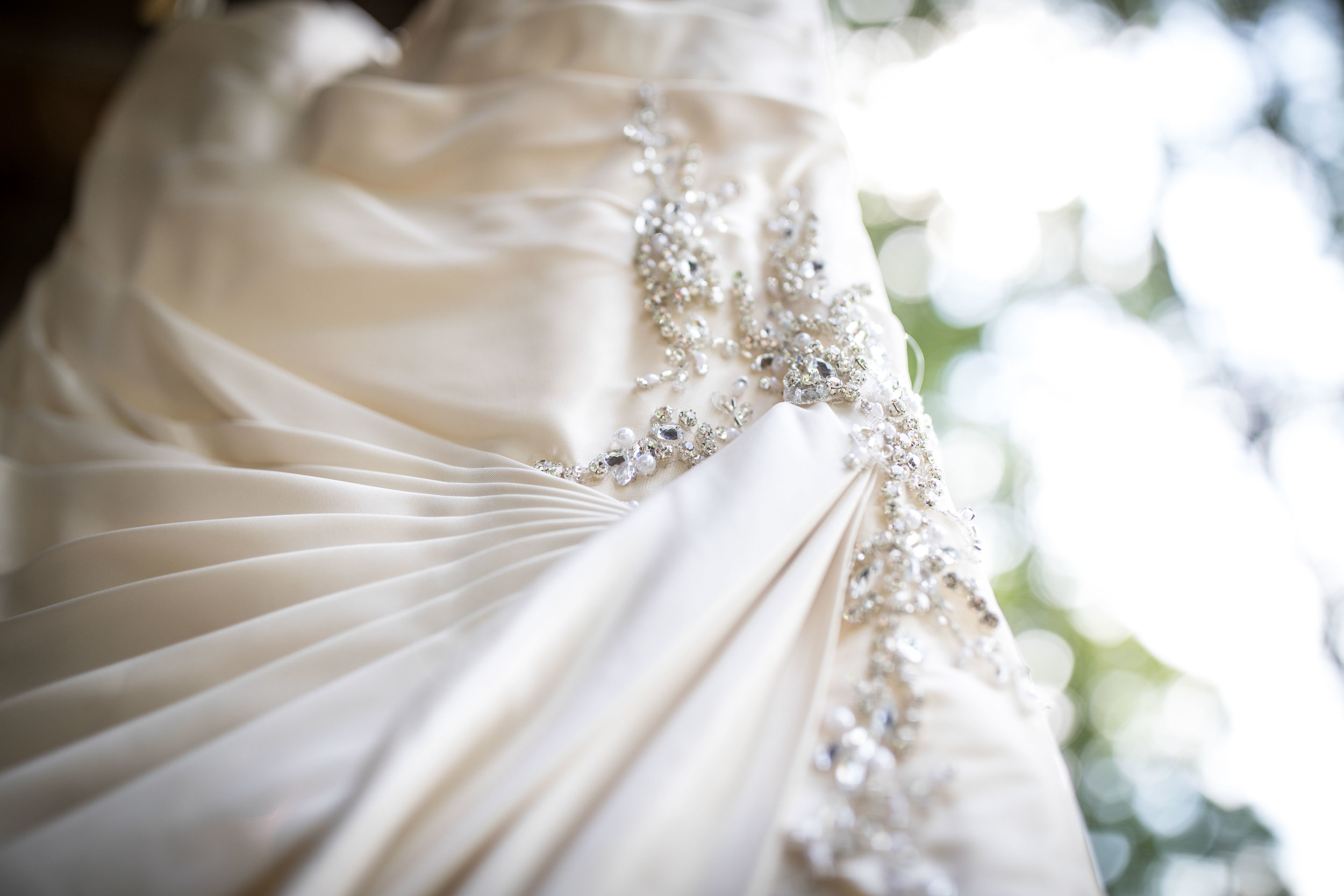  The white wedding dress hung to show close up detail 