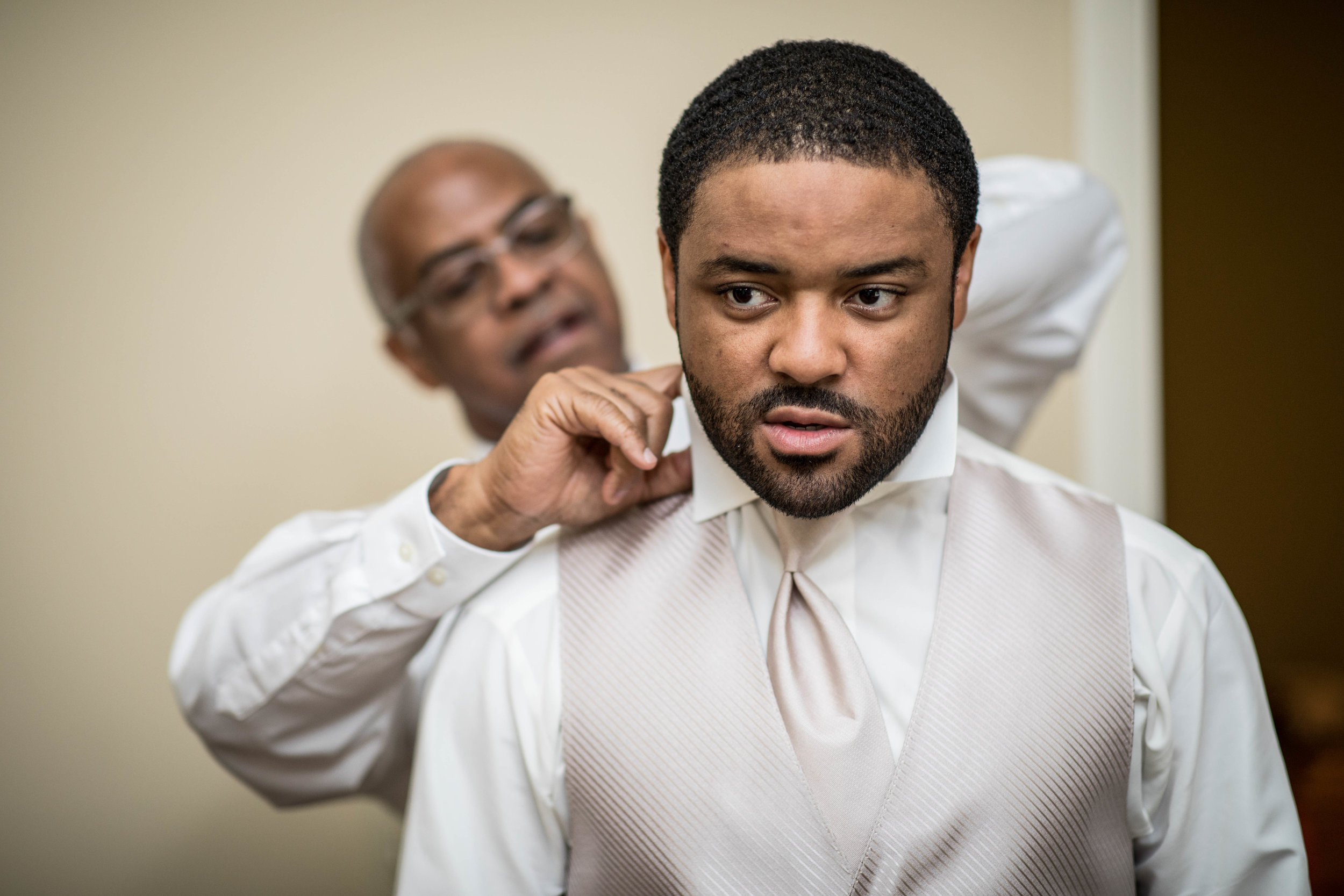  The father of the groom helps to dress the groom 