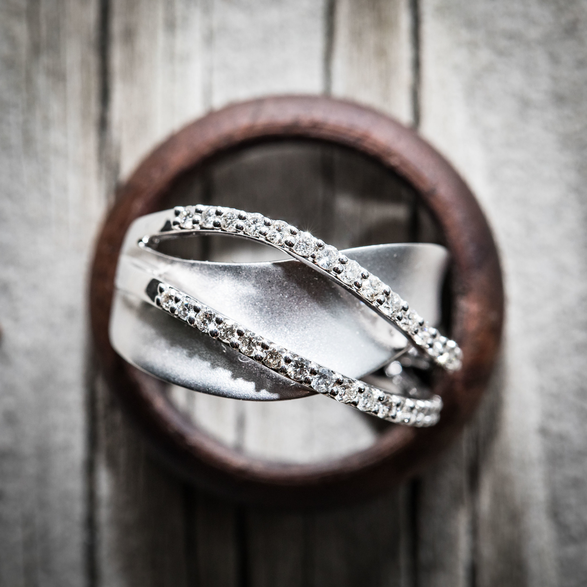  macro photo of rings against a driftwood table 