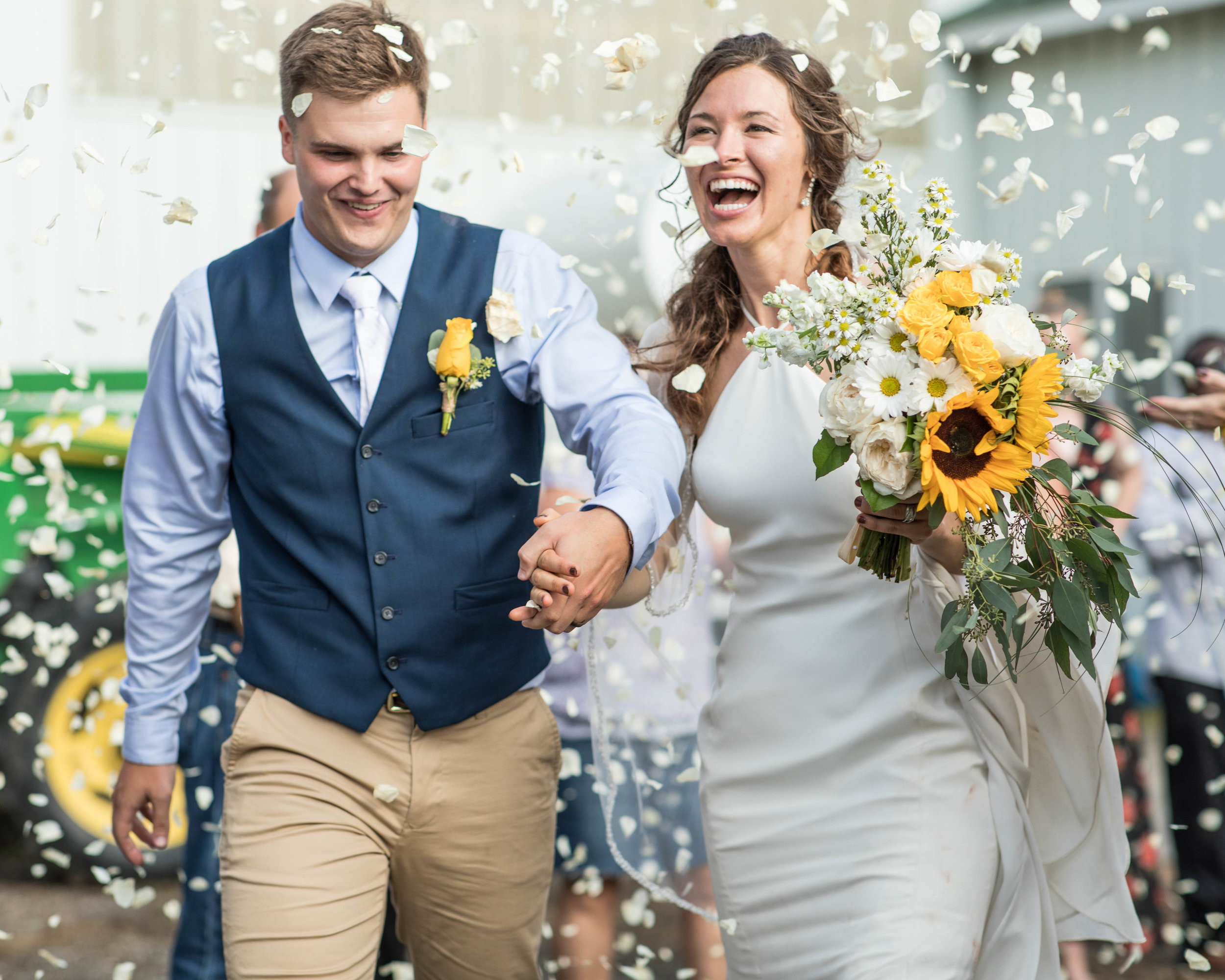 flower pedals are thrown at the bride and groom as they exit for their honeymoon 