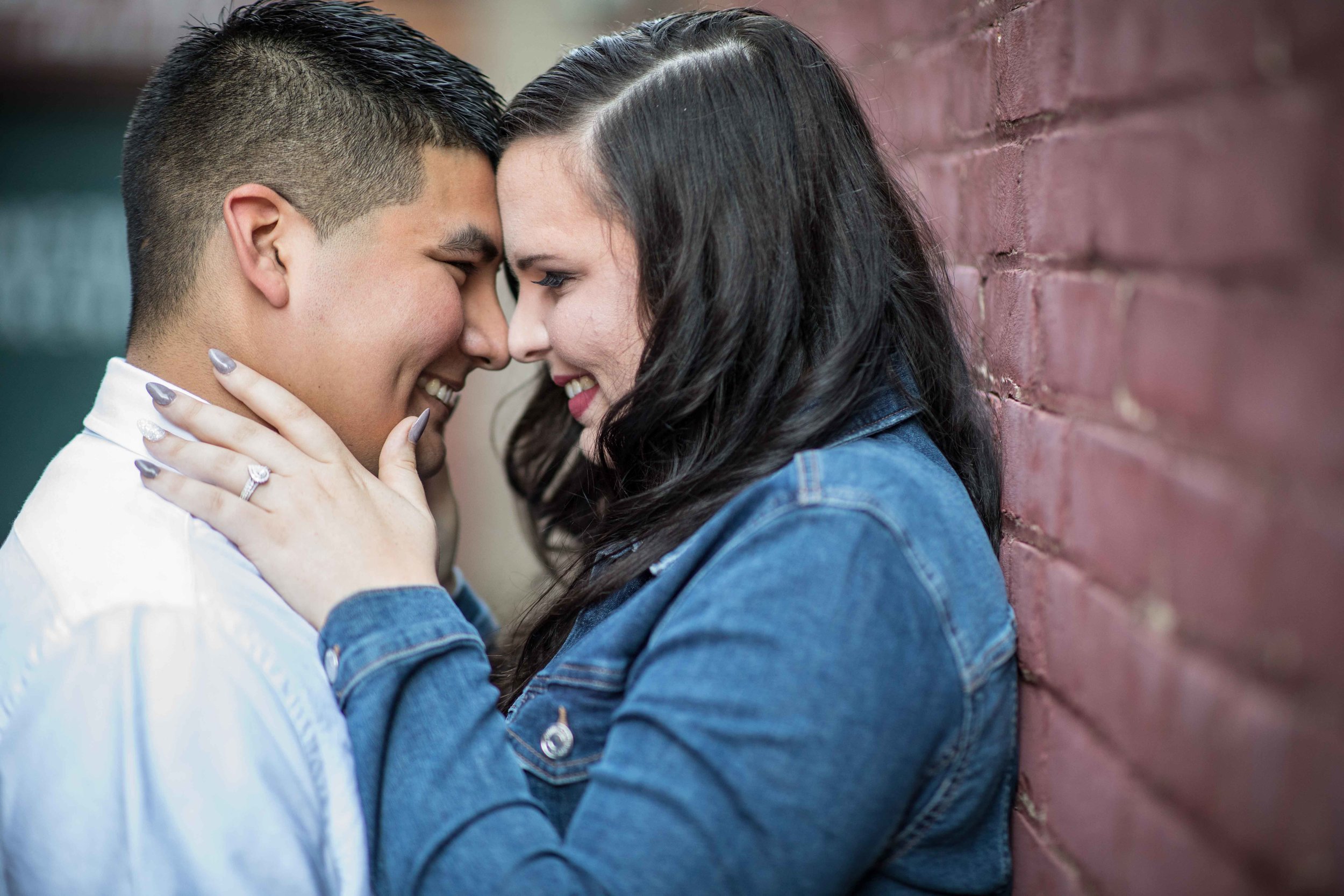  man and woman hold each other close with noses touching 