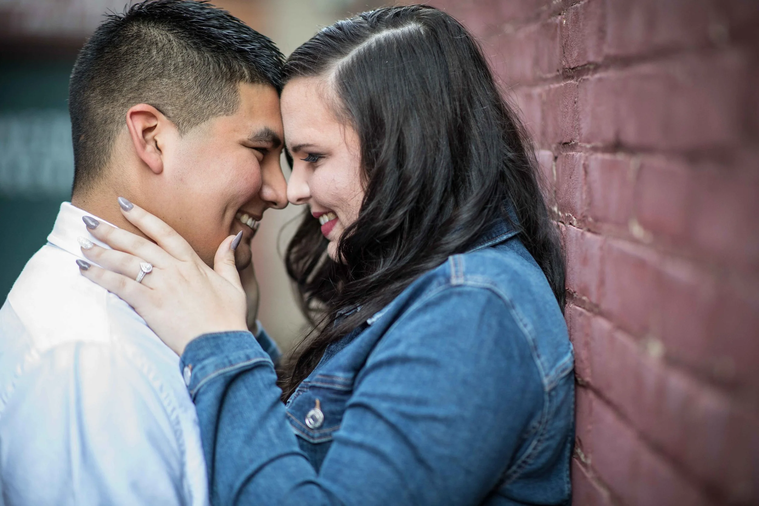 man and woman hold each other close with noses touching