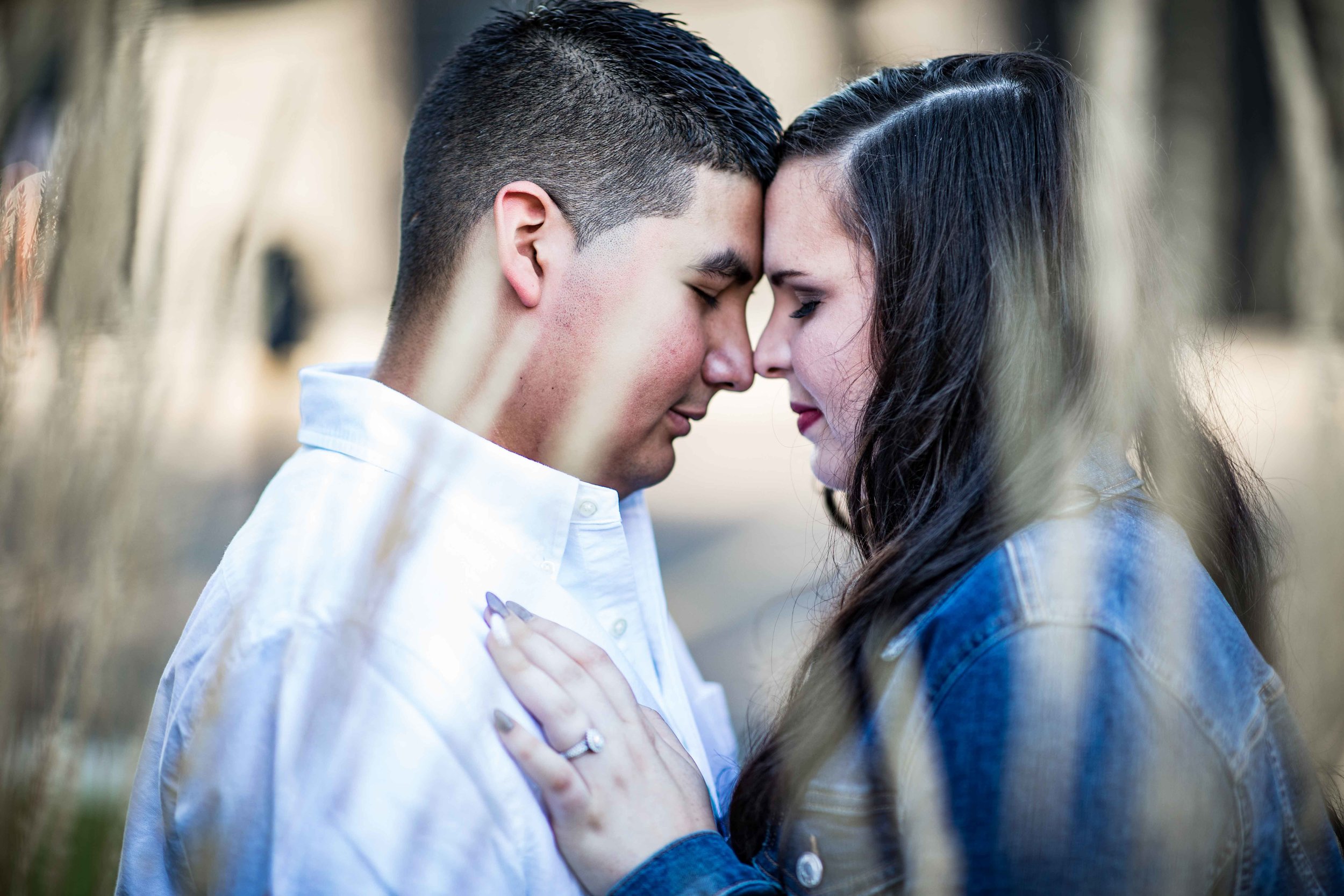  Man and woman seen through the tall grass as they take a quiet moment of reflection  