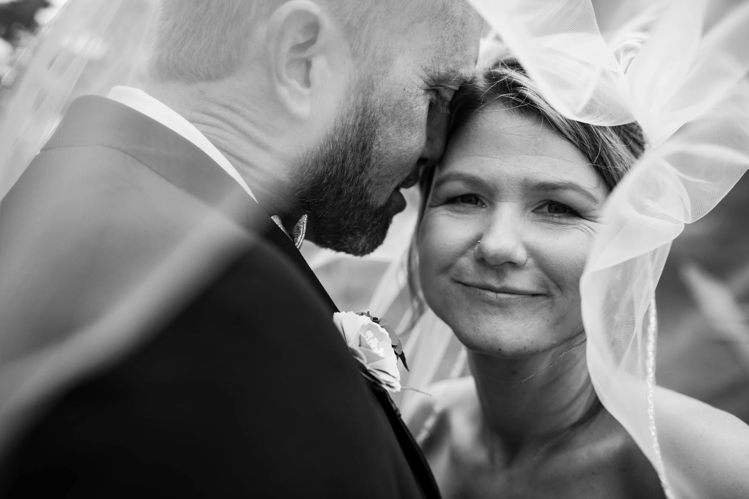 bride and groom photographed through the veil.