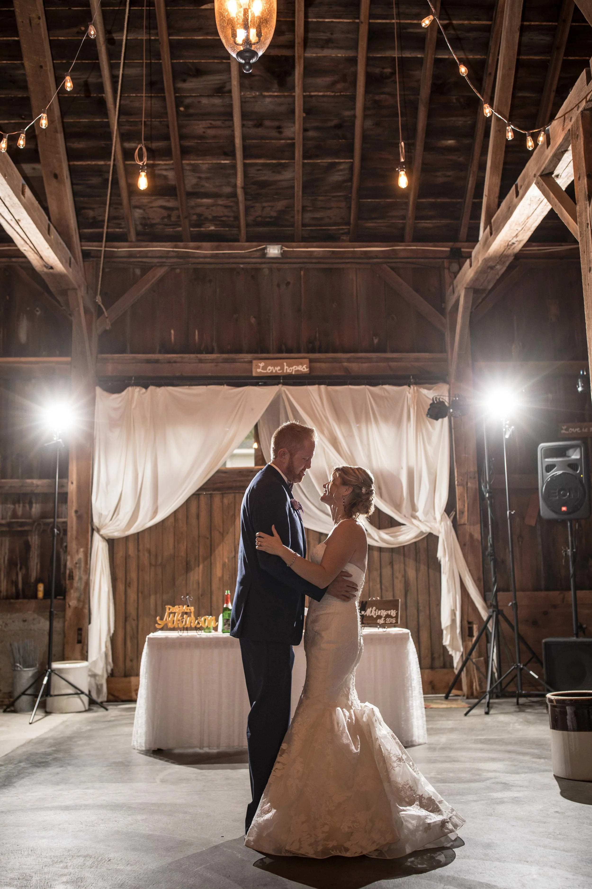 First dance as husband and wife with off camera flashes in the background