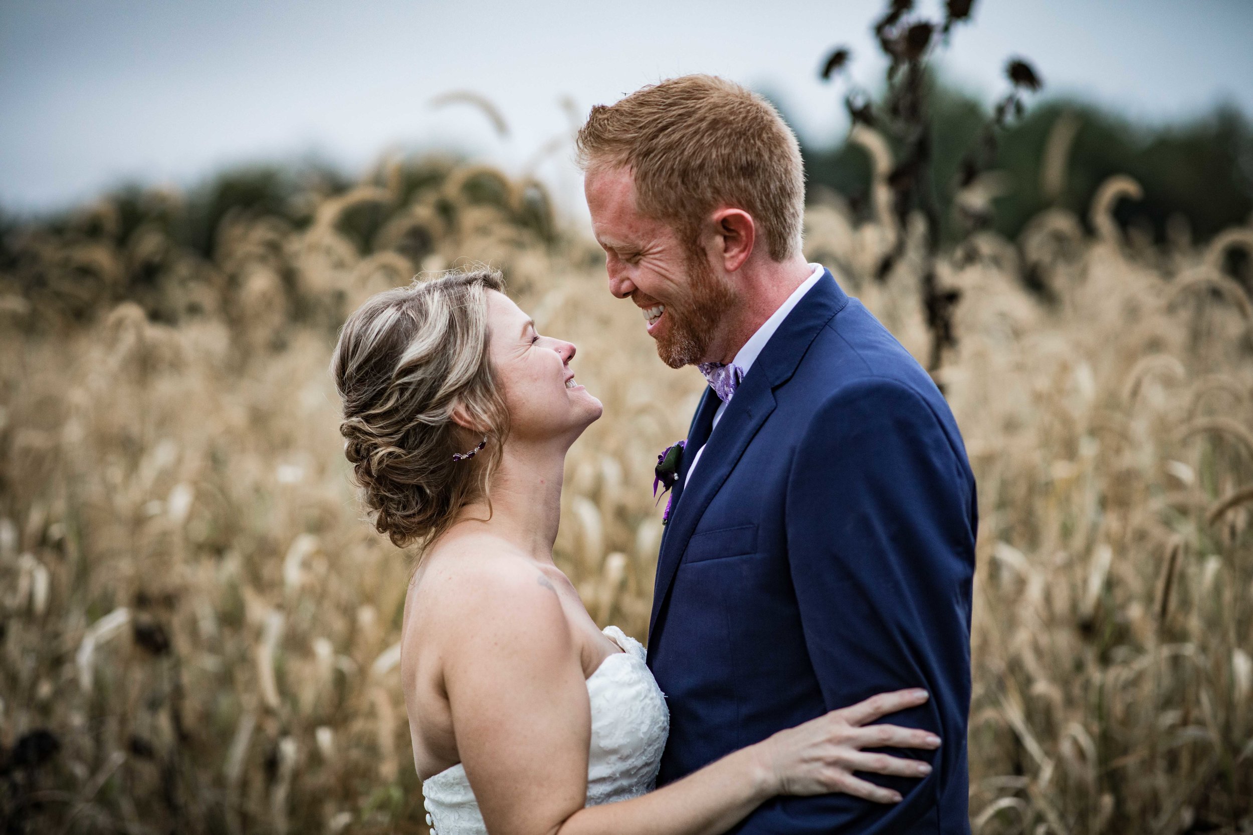  bride and groom portrait in front of a golden autumn field 