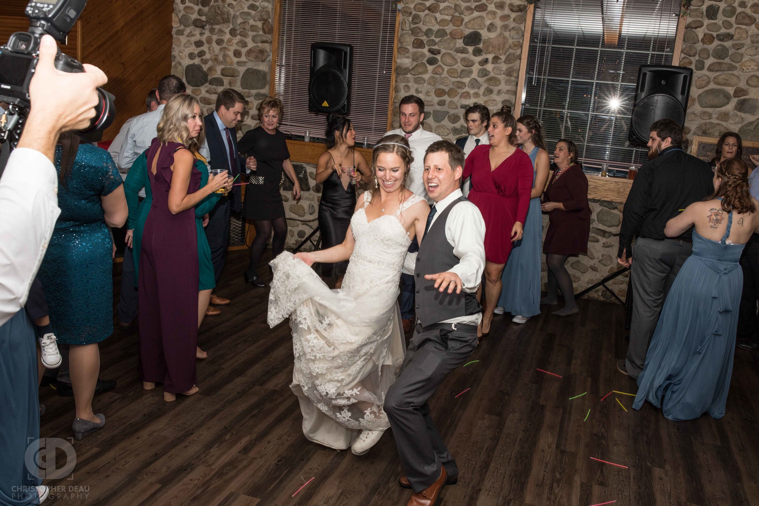  Bride and Groom dancing in a crowd during the reception  