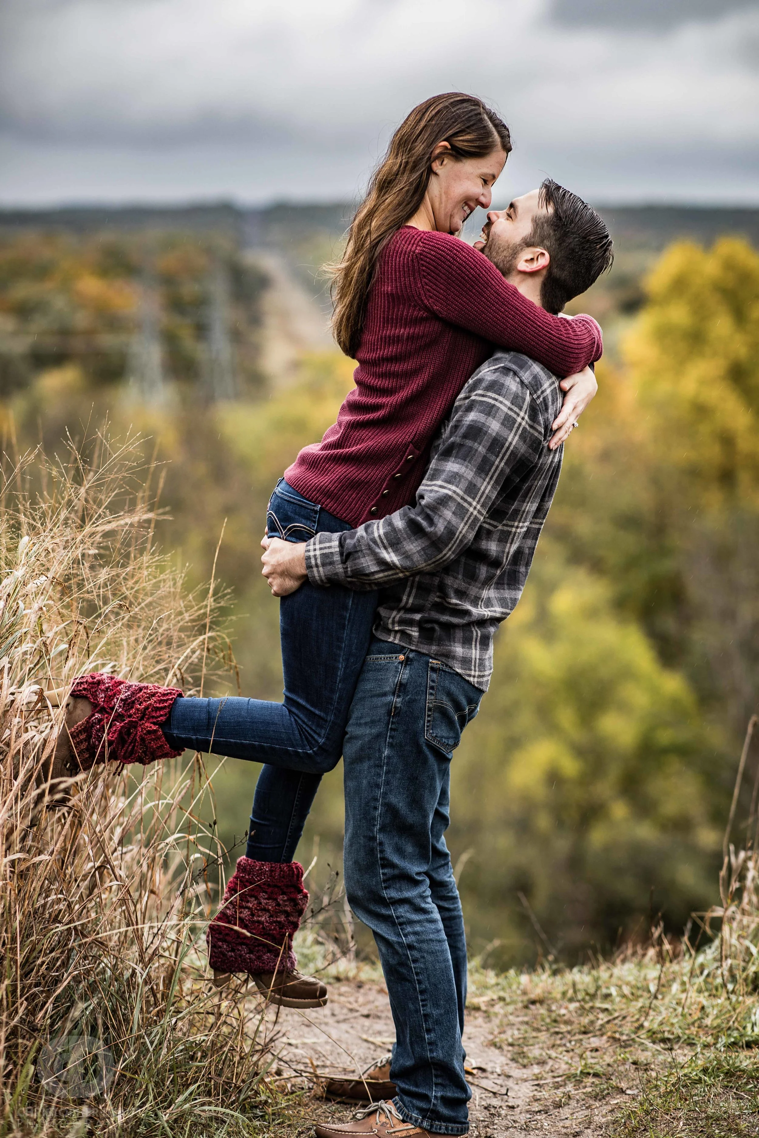 man picking up woman to kiss her at a bluff overlook in Kalamazoo Michigan