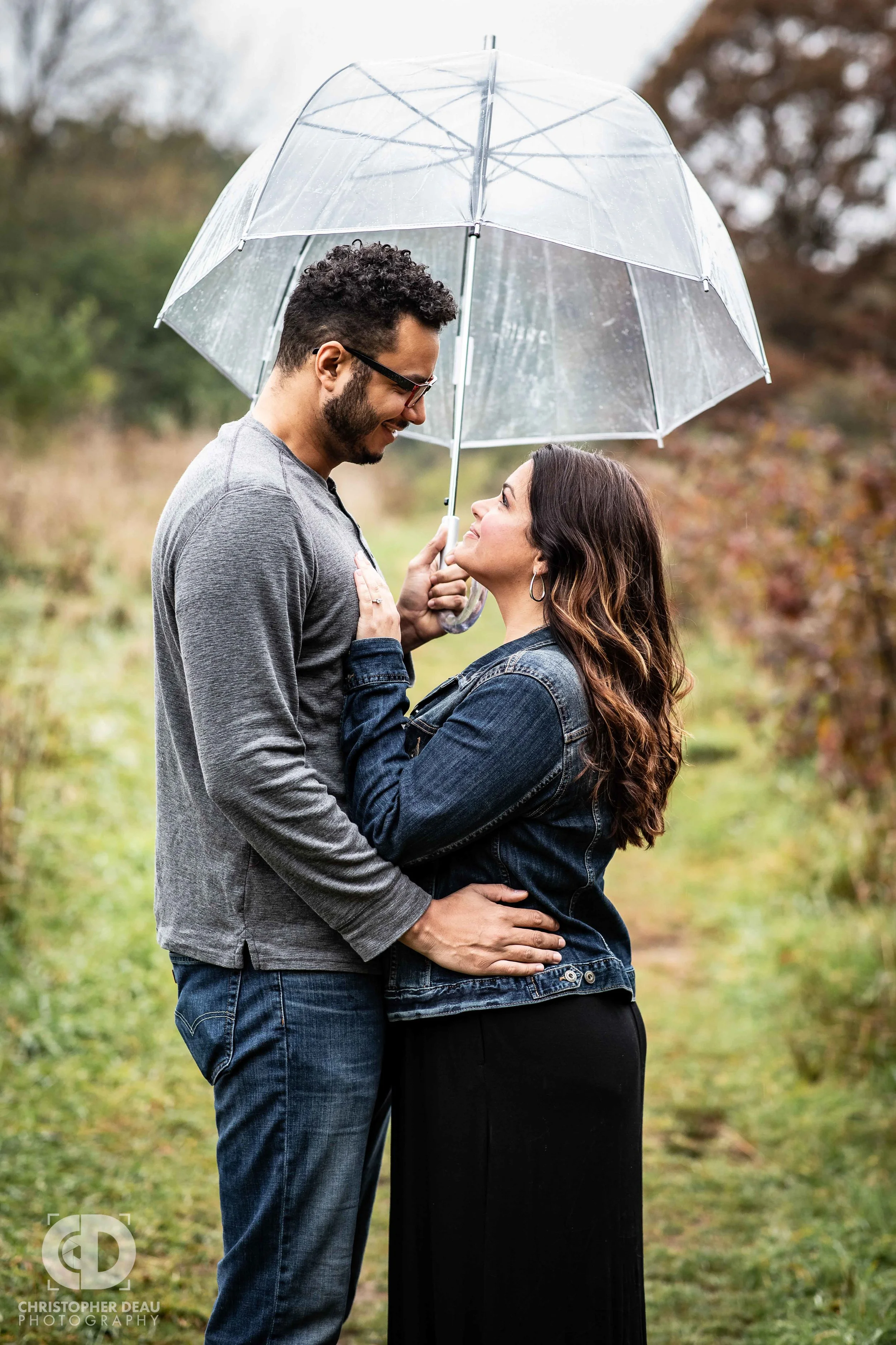 Clear bubble umbrella with a couple holding each other