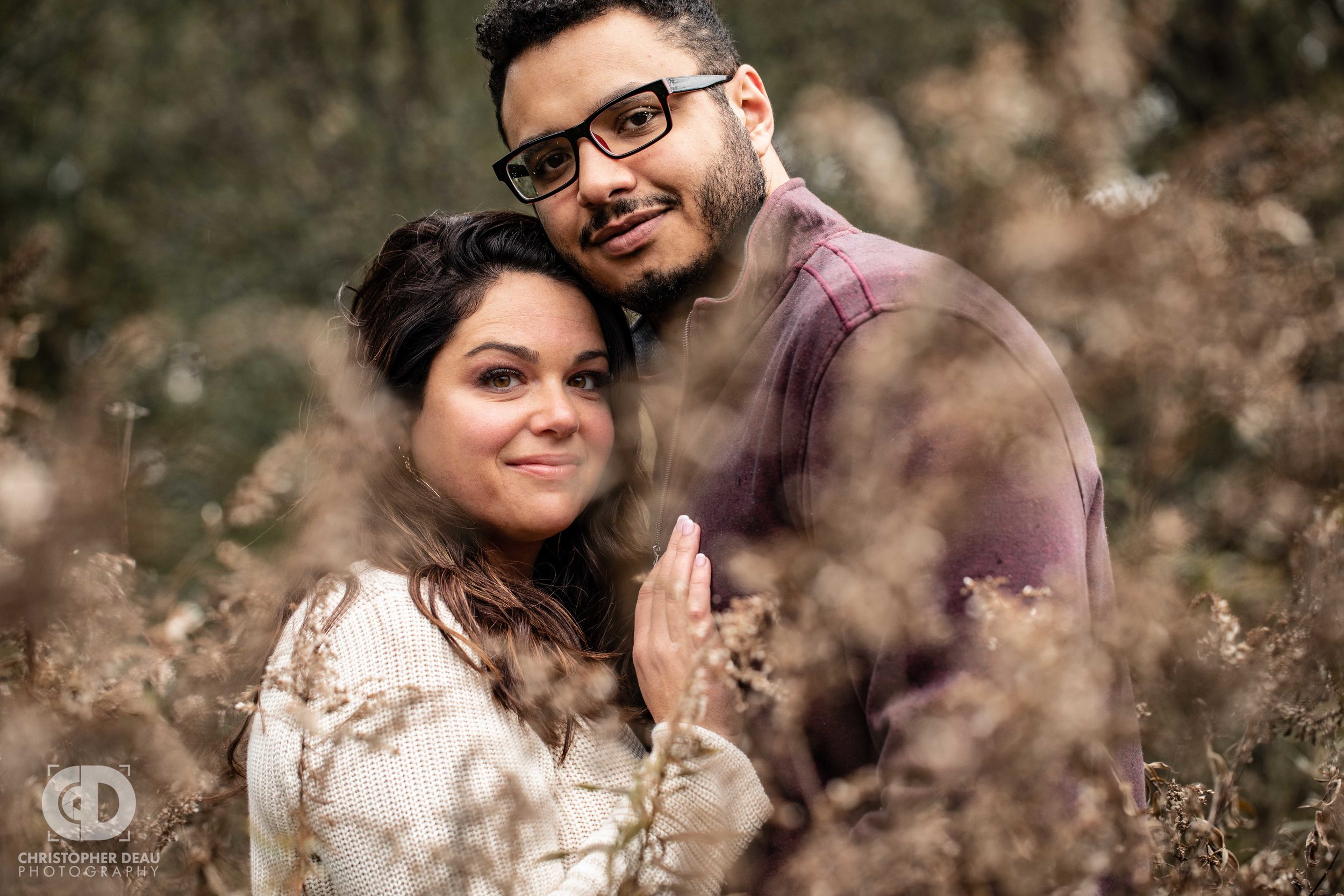  Man and woman in a southwest michigan tall grass prairie fall engagement photos 