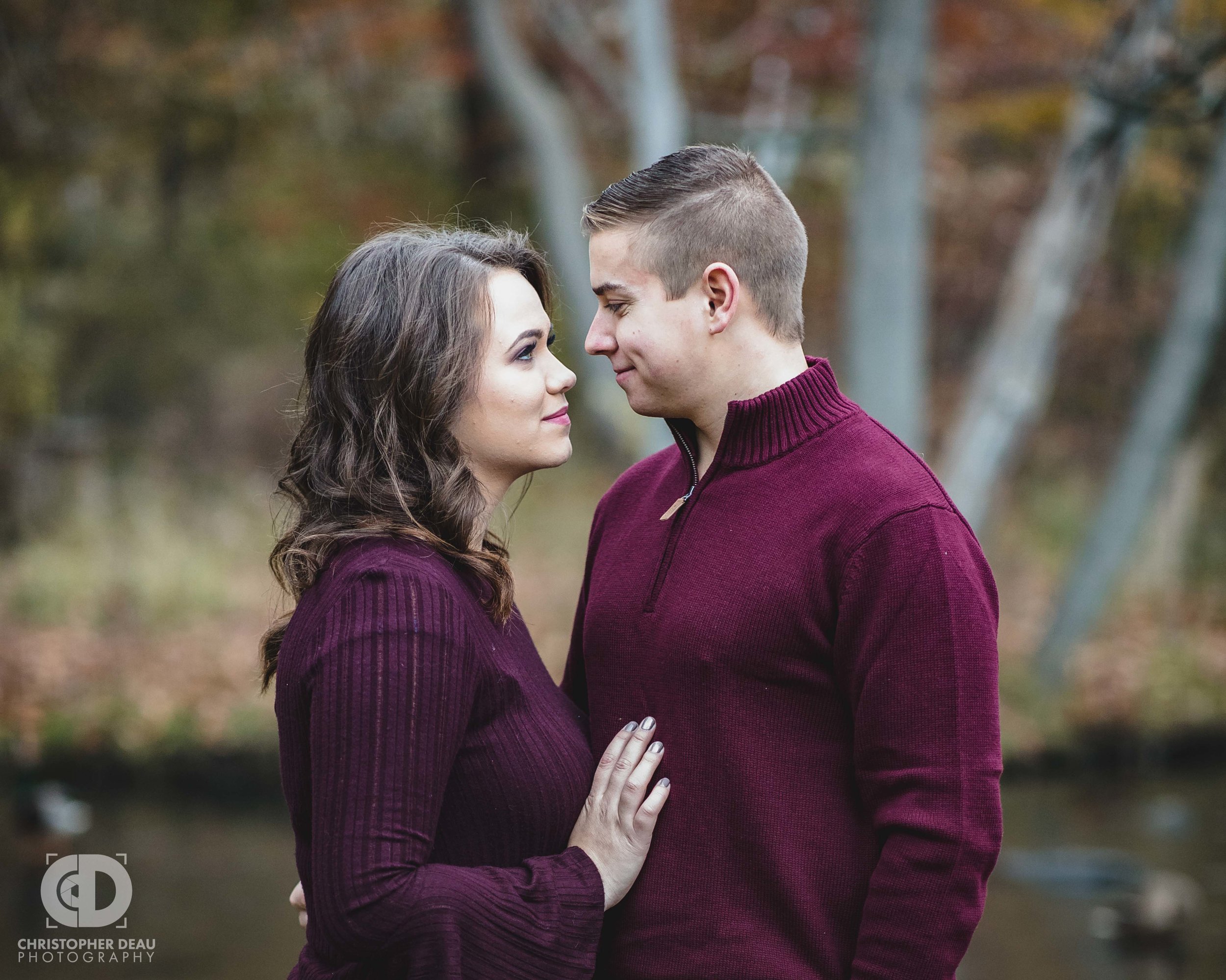  Couple looks at each other with stream and ducks in the southwest Michigan background 