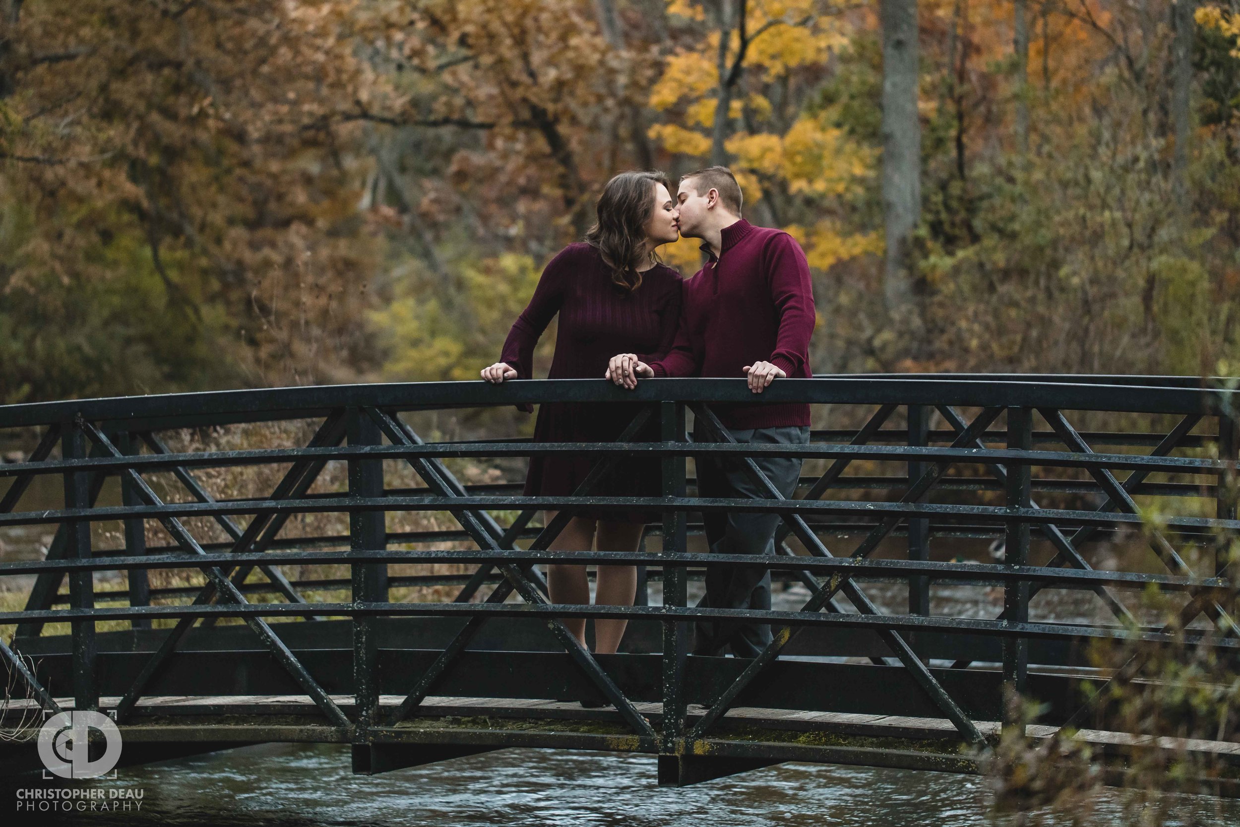  couple kissing on a bridge over a stream in Southwest Michigan 