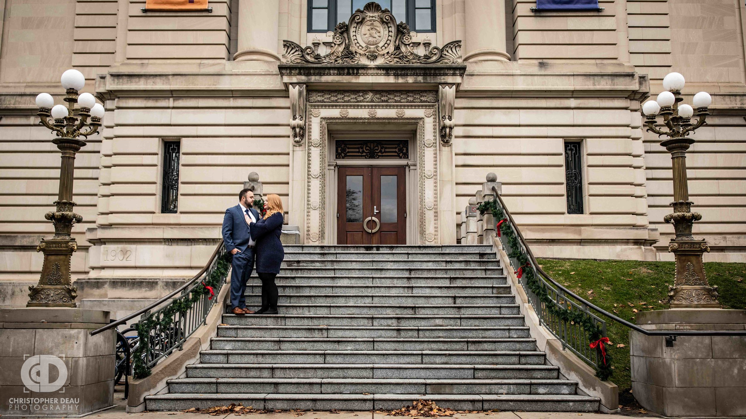  A couple poses on the steps of the Grand Rapids Public Library for their engagement photos 