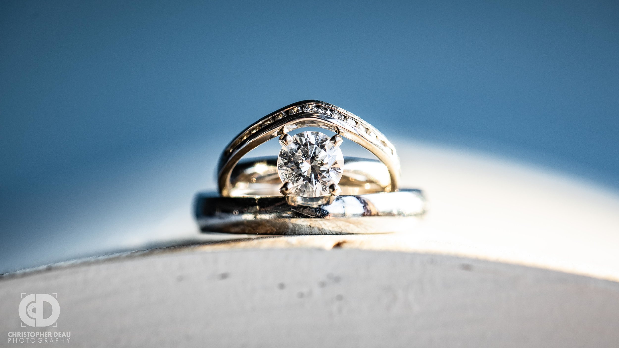  close up detail on wedding bands and engagement ring with diamonds 