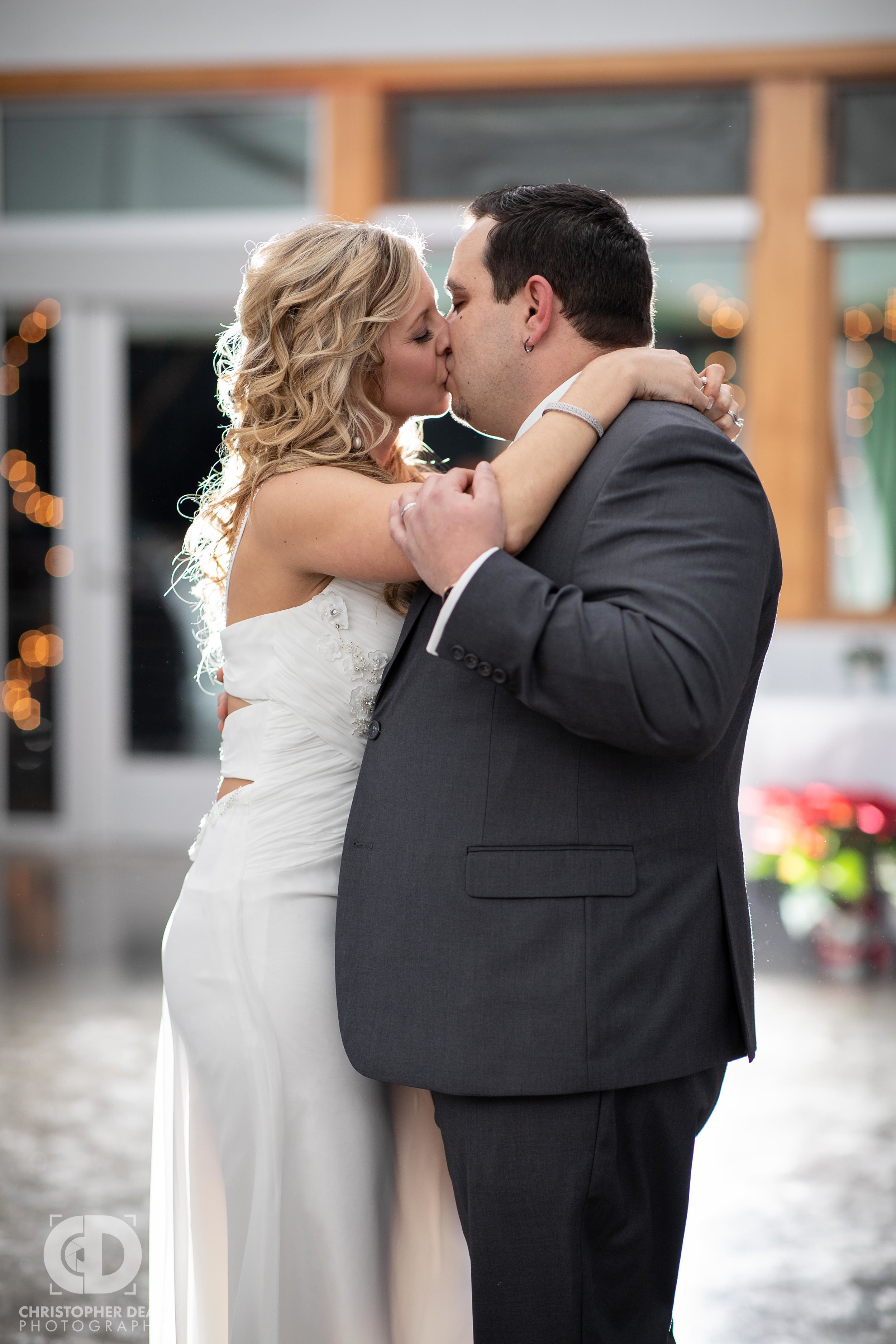  Bride and Groom share a kiss during their first dance at the Girl Scouts building in Kalamazoo at their wedding reception 