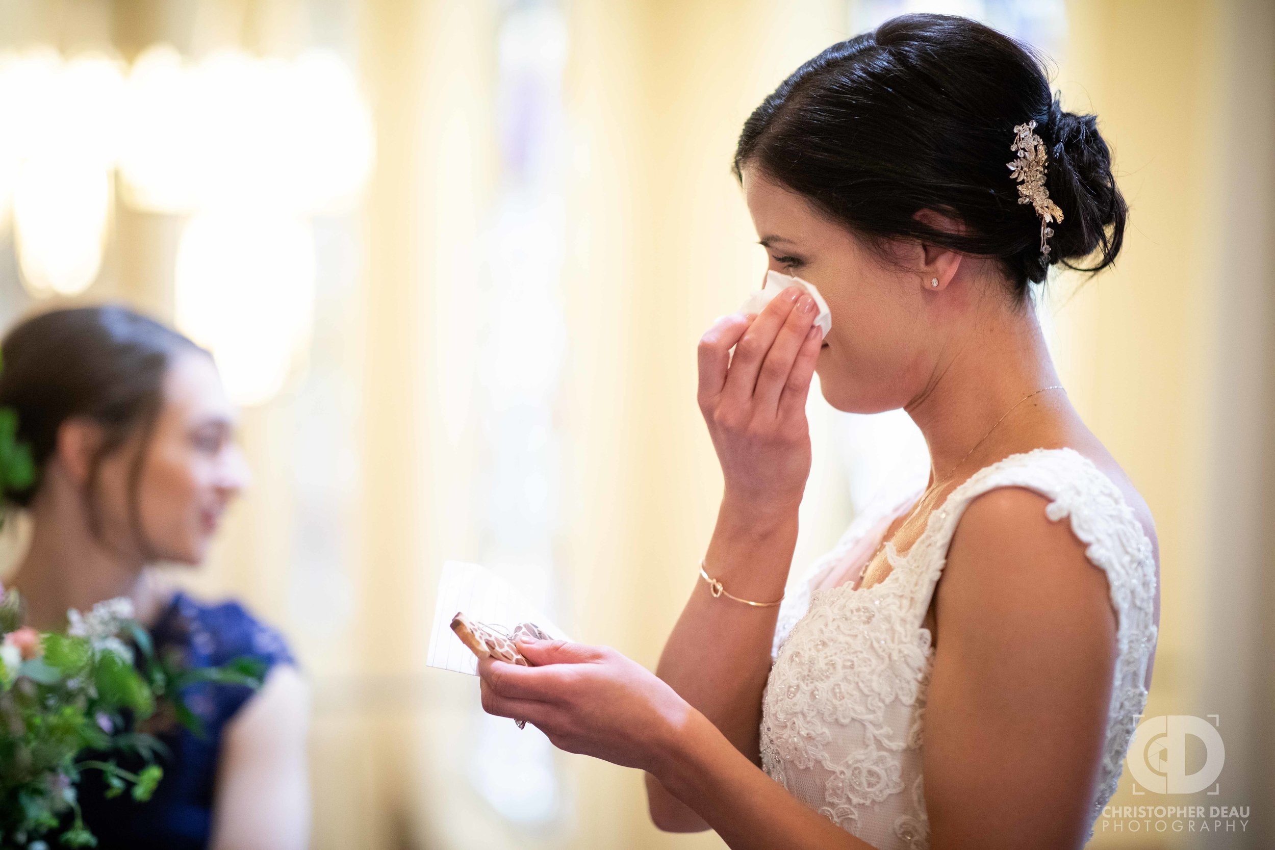  The bride crying while reading a letter from the groom 