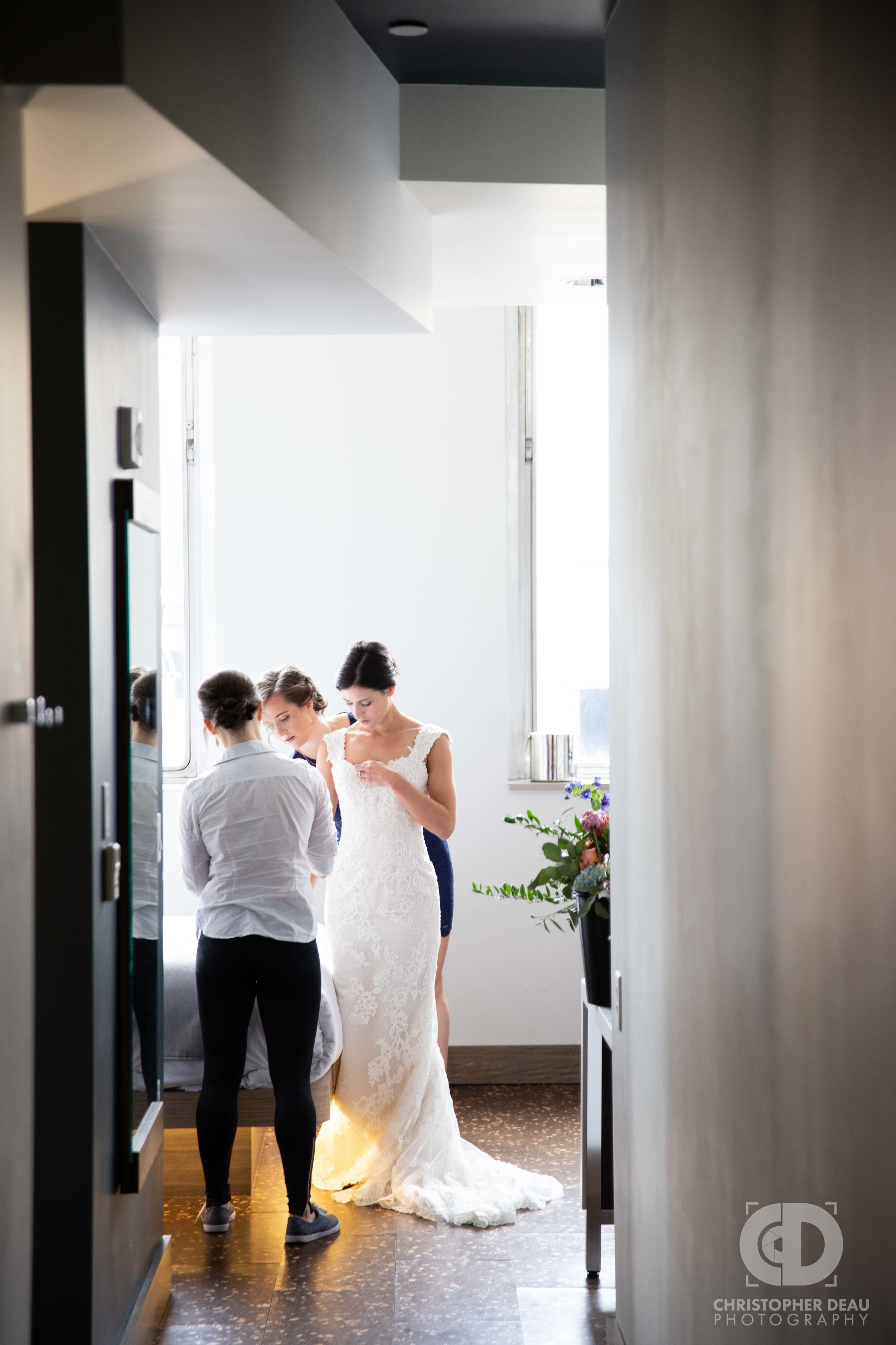 Bridesmaids helping Bride