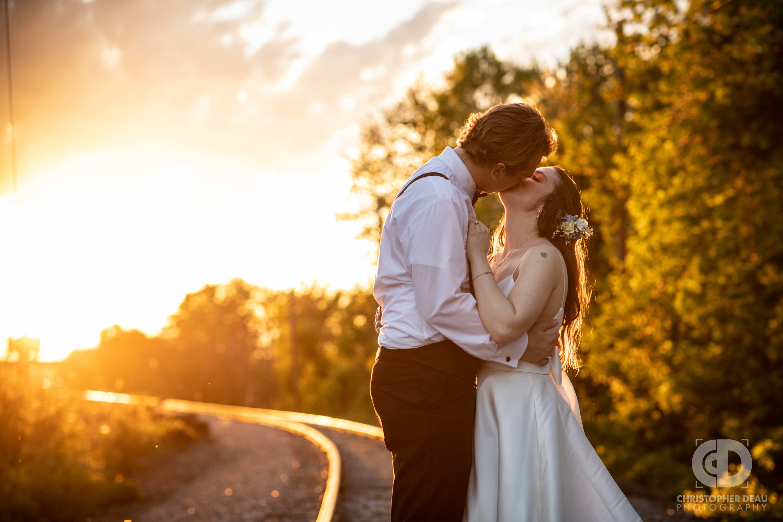  bride and groom kissing during golden hour sunset 