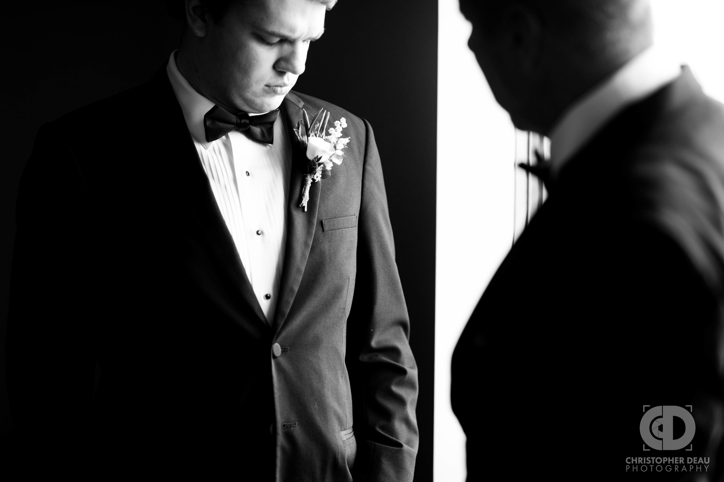  Groom getting boutonniere placed by his father 