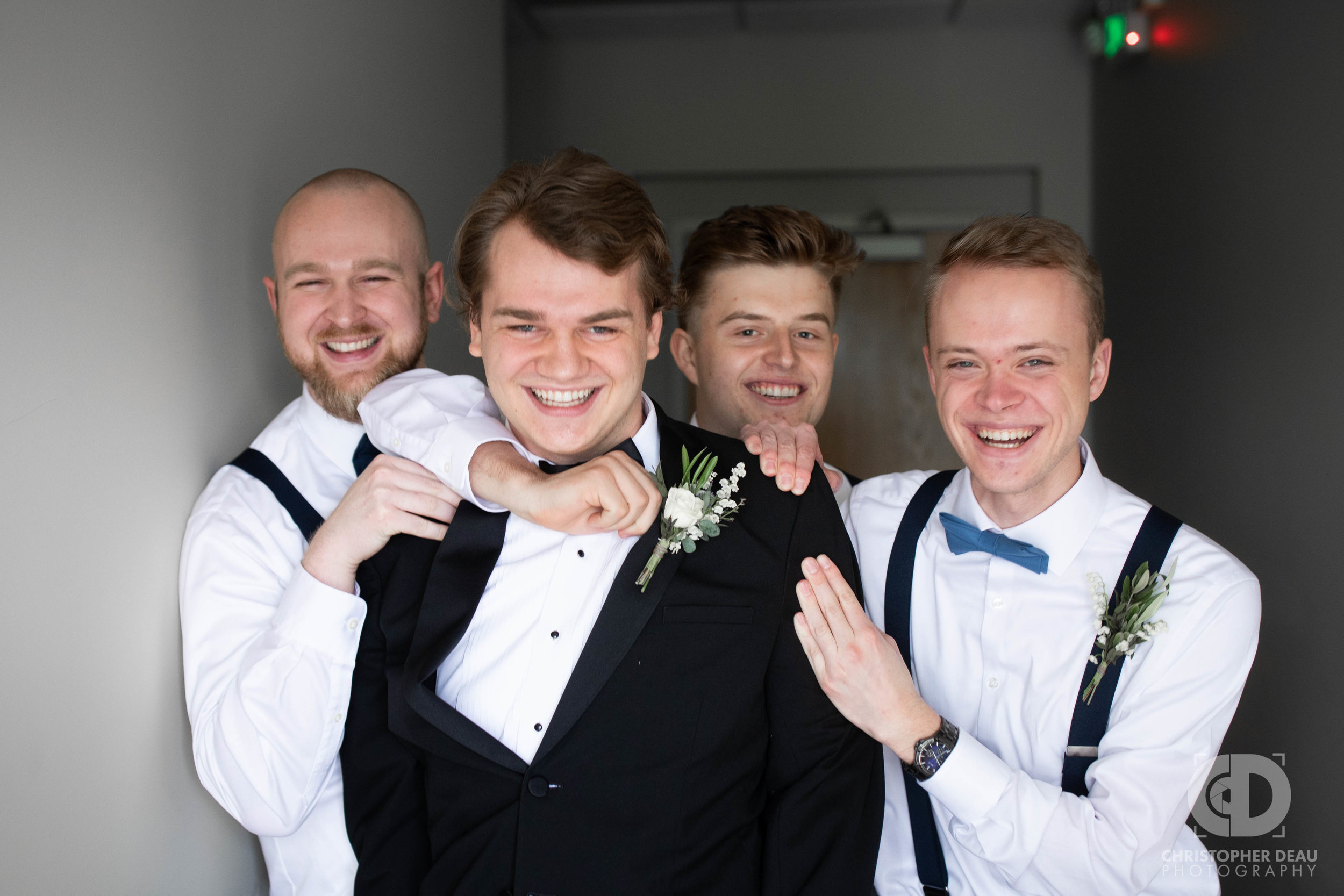  groom and groomsmen laughing 