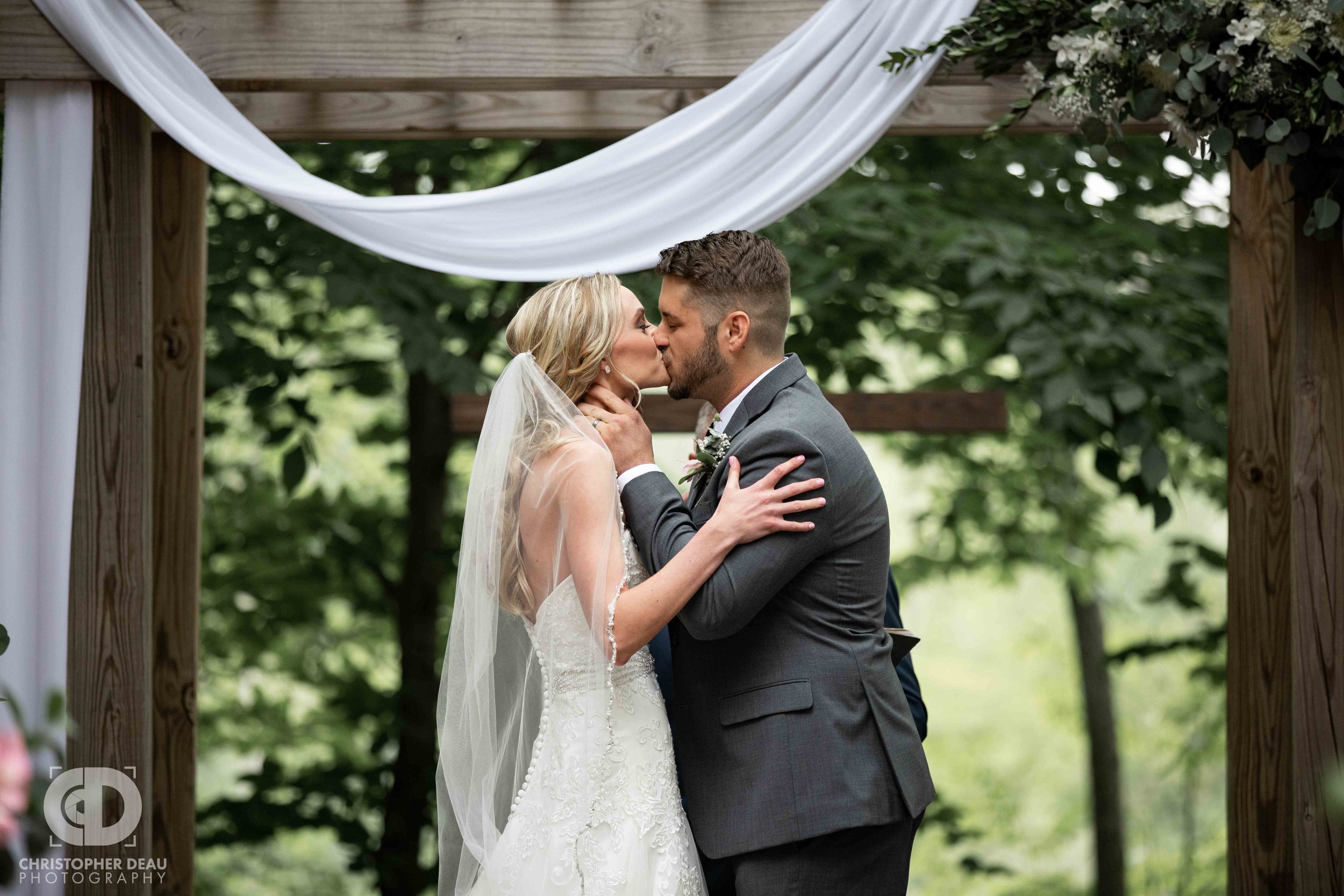  bride and groom first kiss at the ceremony 