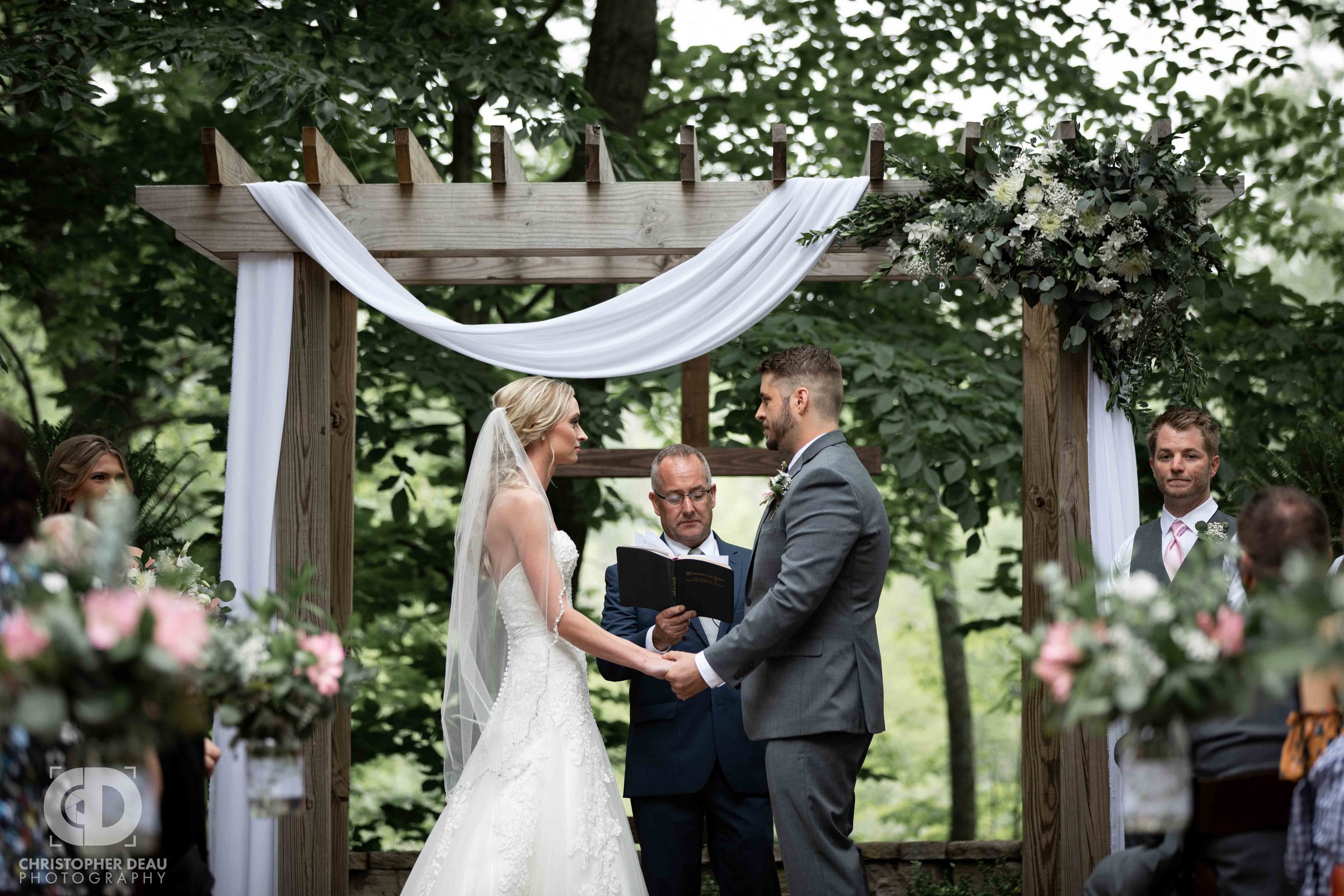  bride and groom holding hands during the ceremony 