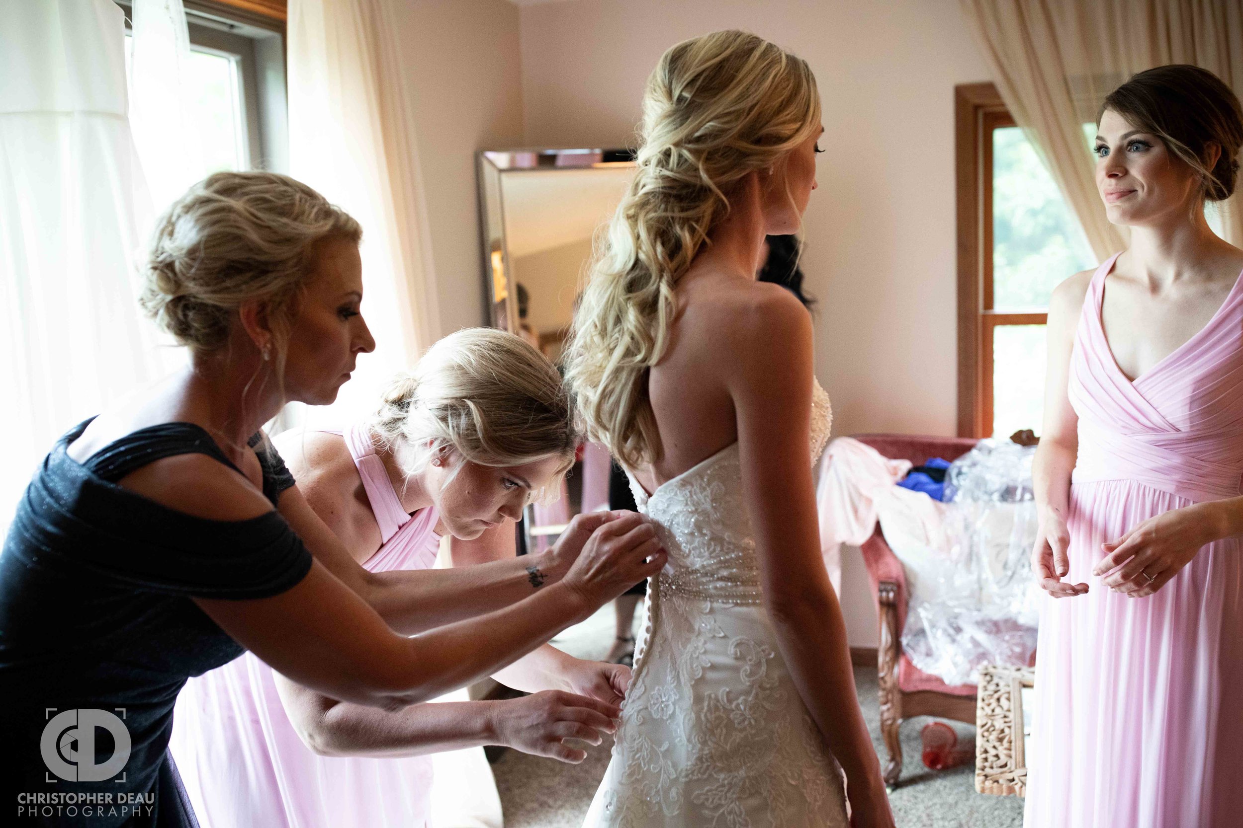  bride getting her gown zipped up 