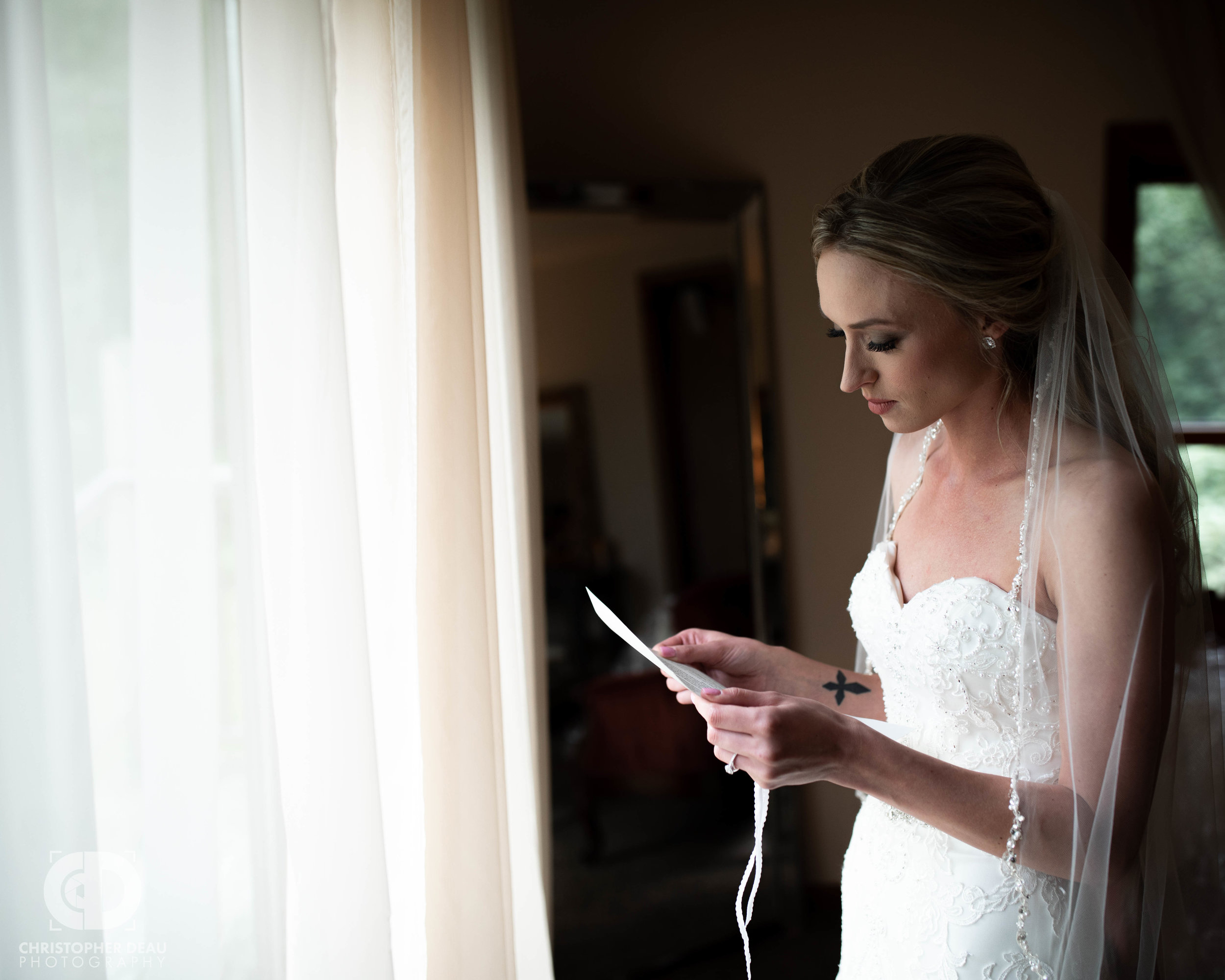  bride reading her letter from the groom 