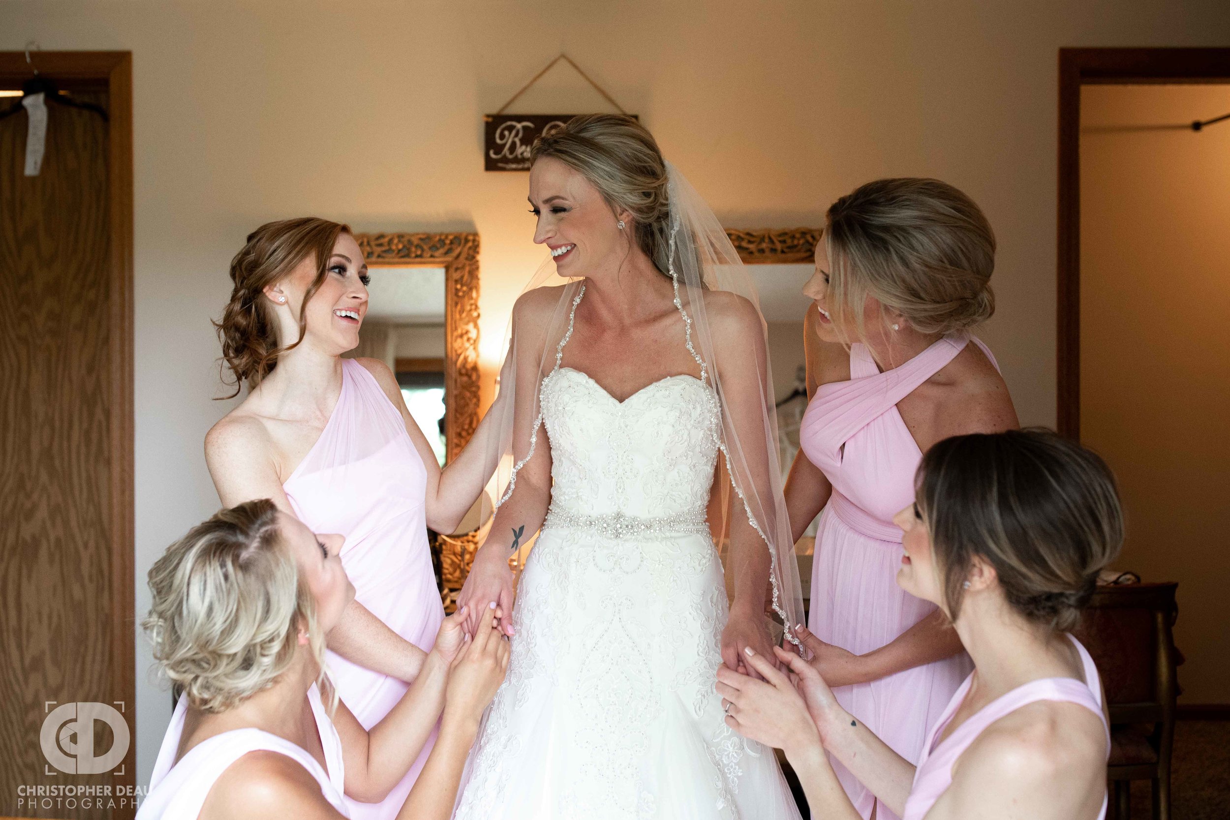  bridesmaids getting the bride ready 