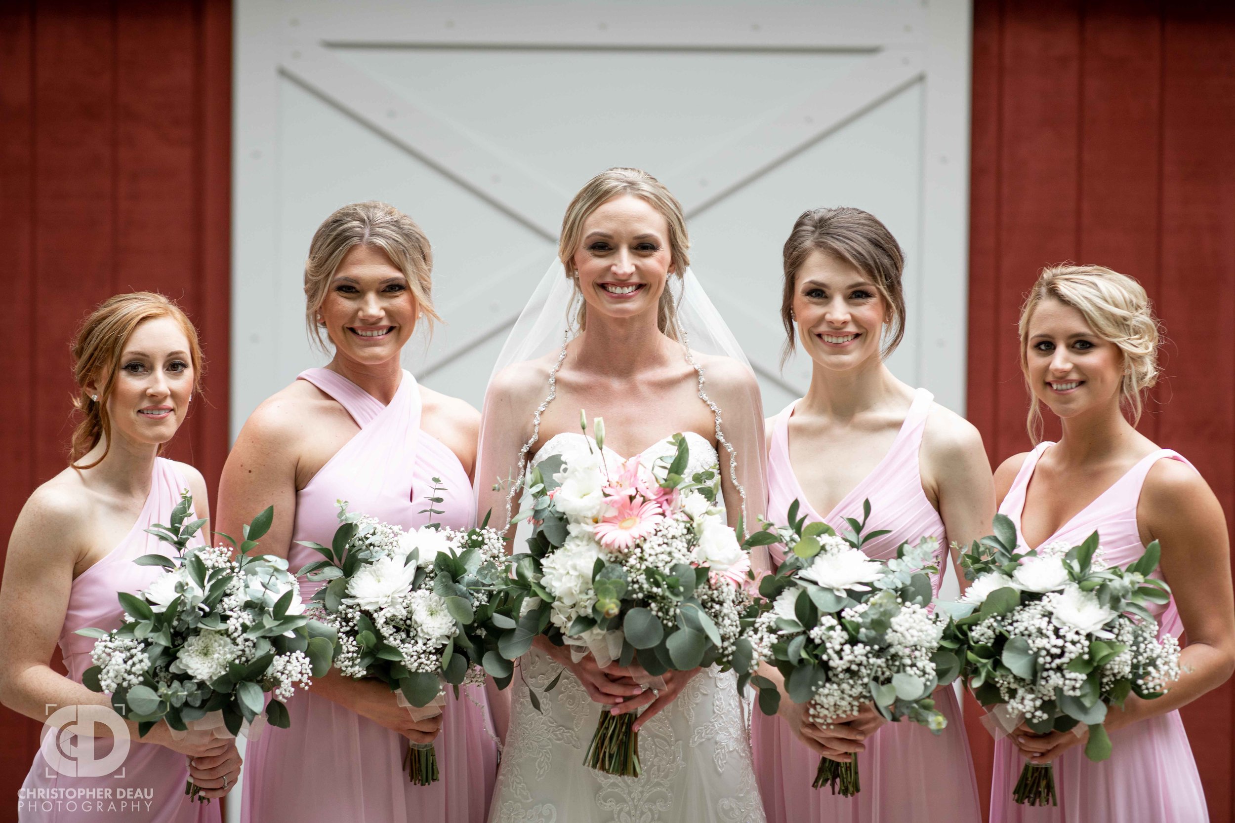  bridesmaids and bride with flowers 