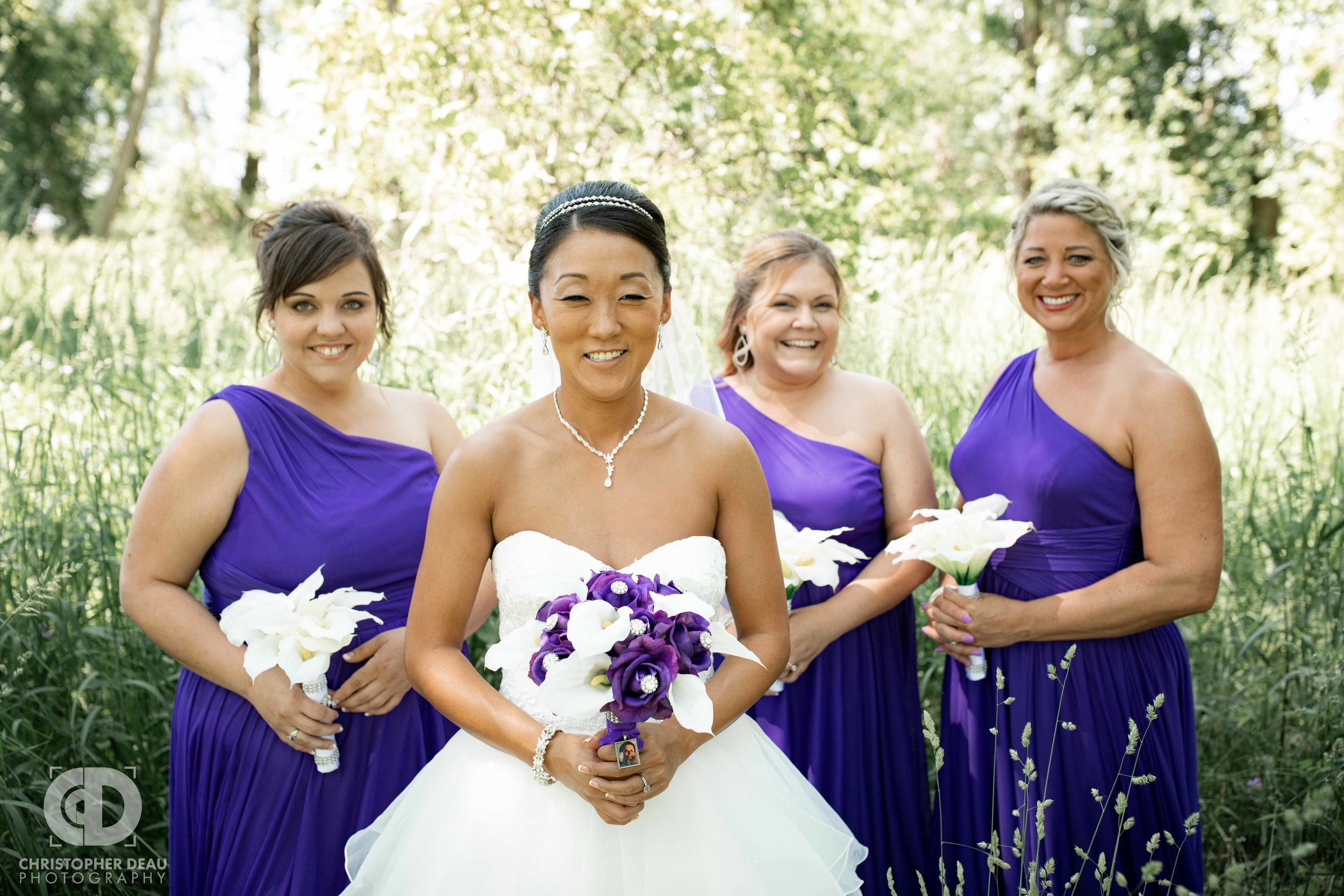  Bridesmaids with bride in tall grass 