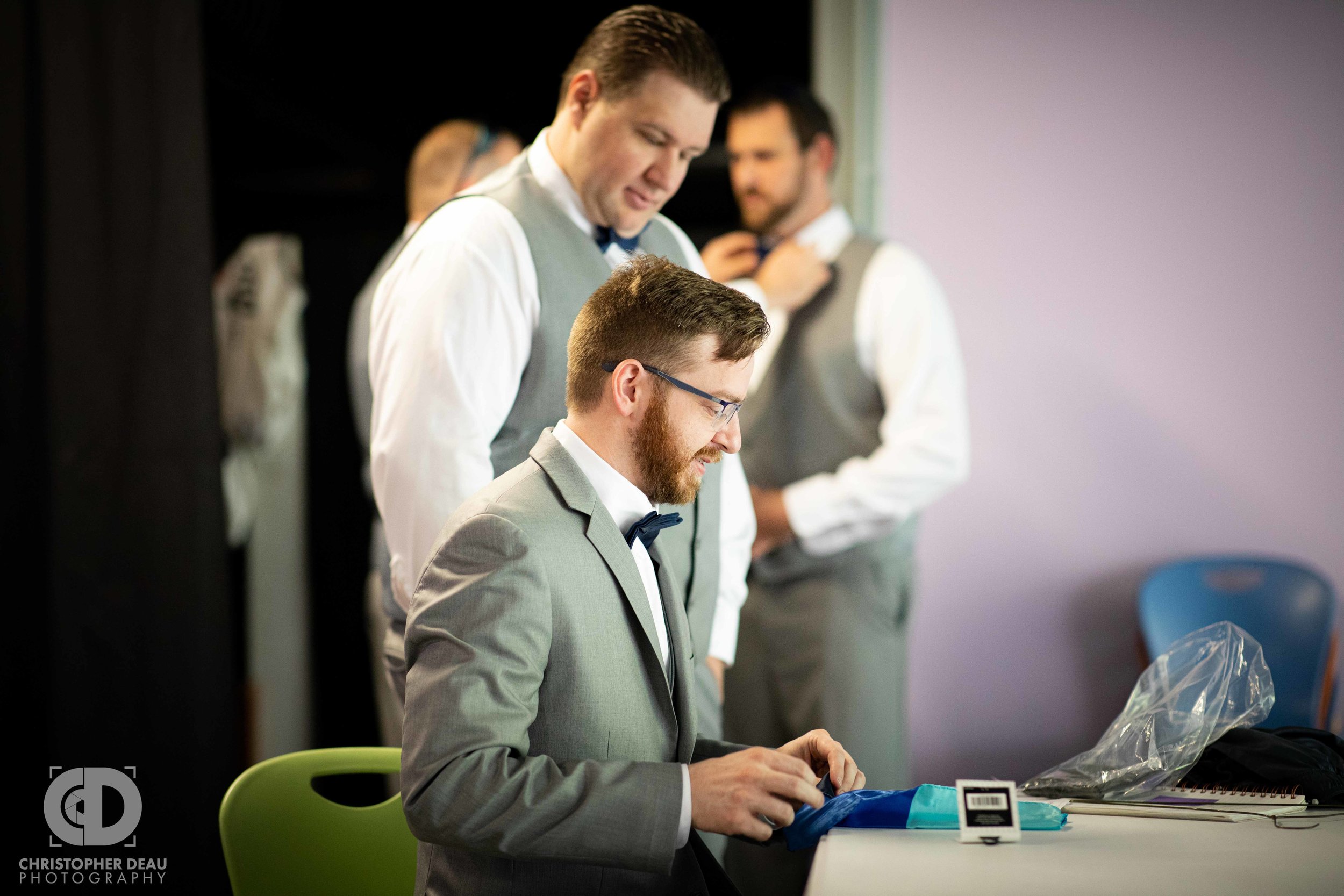  groom folding his pocket square 