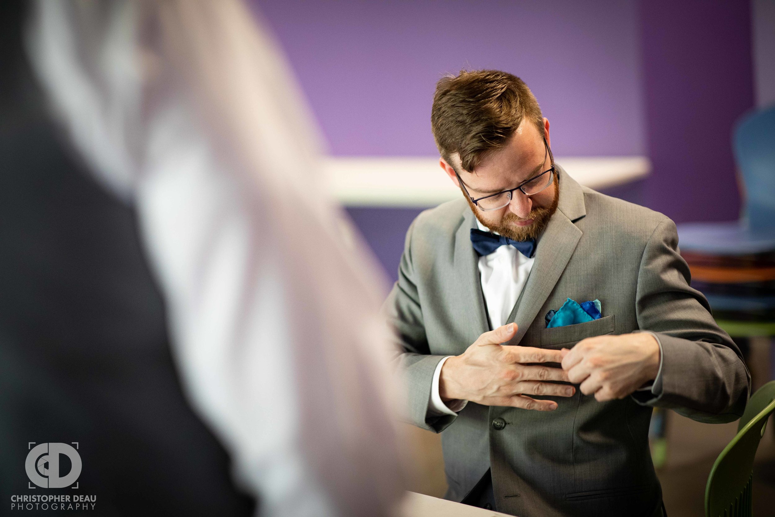  groom fitting his pocket square 