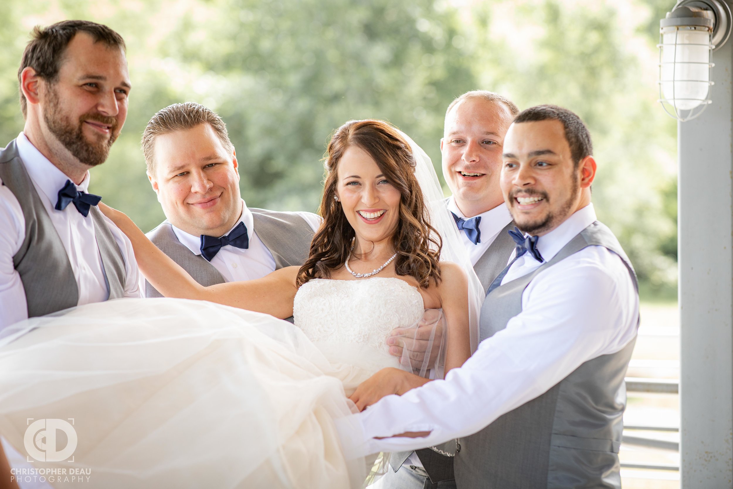  groomsmen lift up the bride 