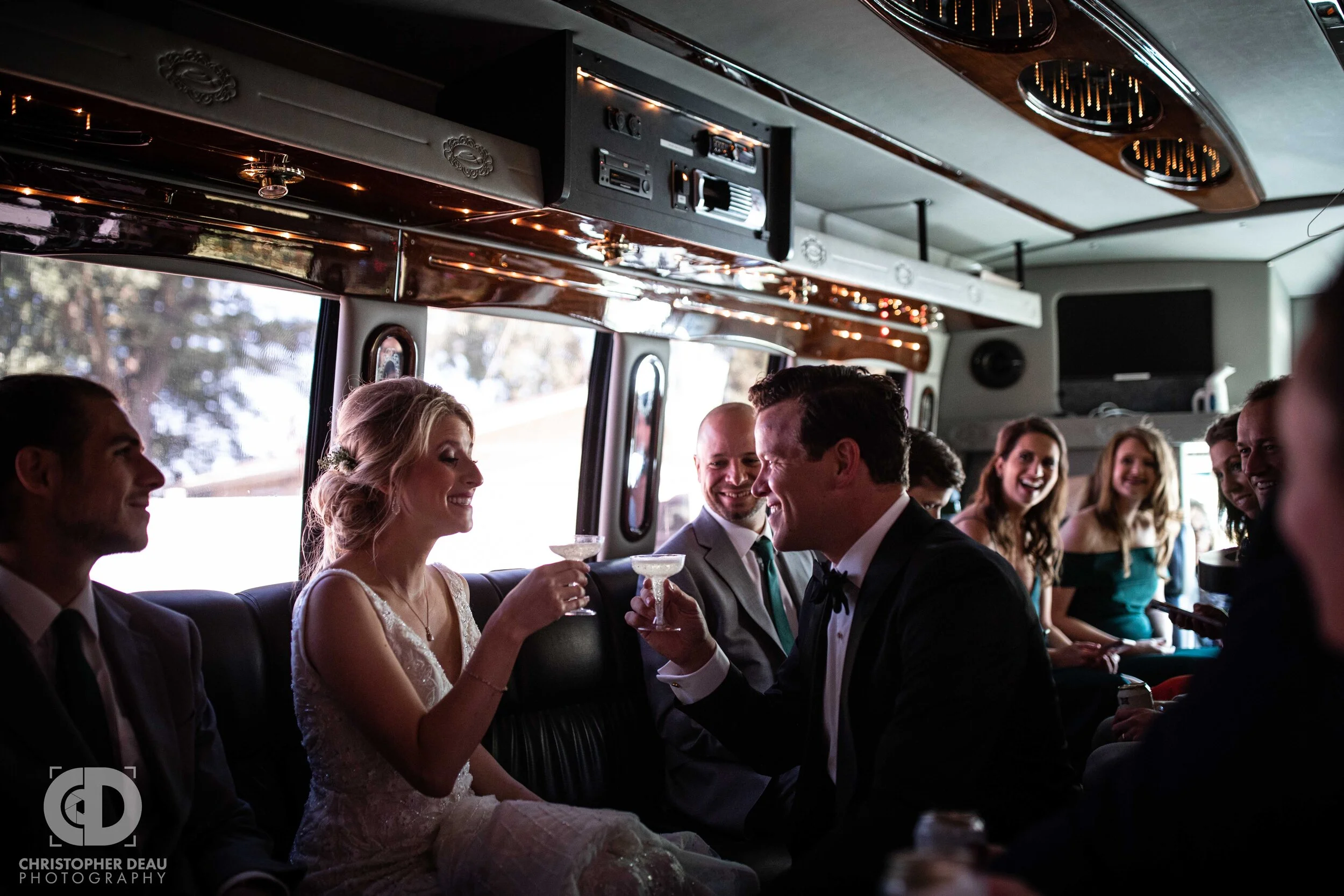 bride and groom toast on the party bus