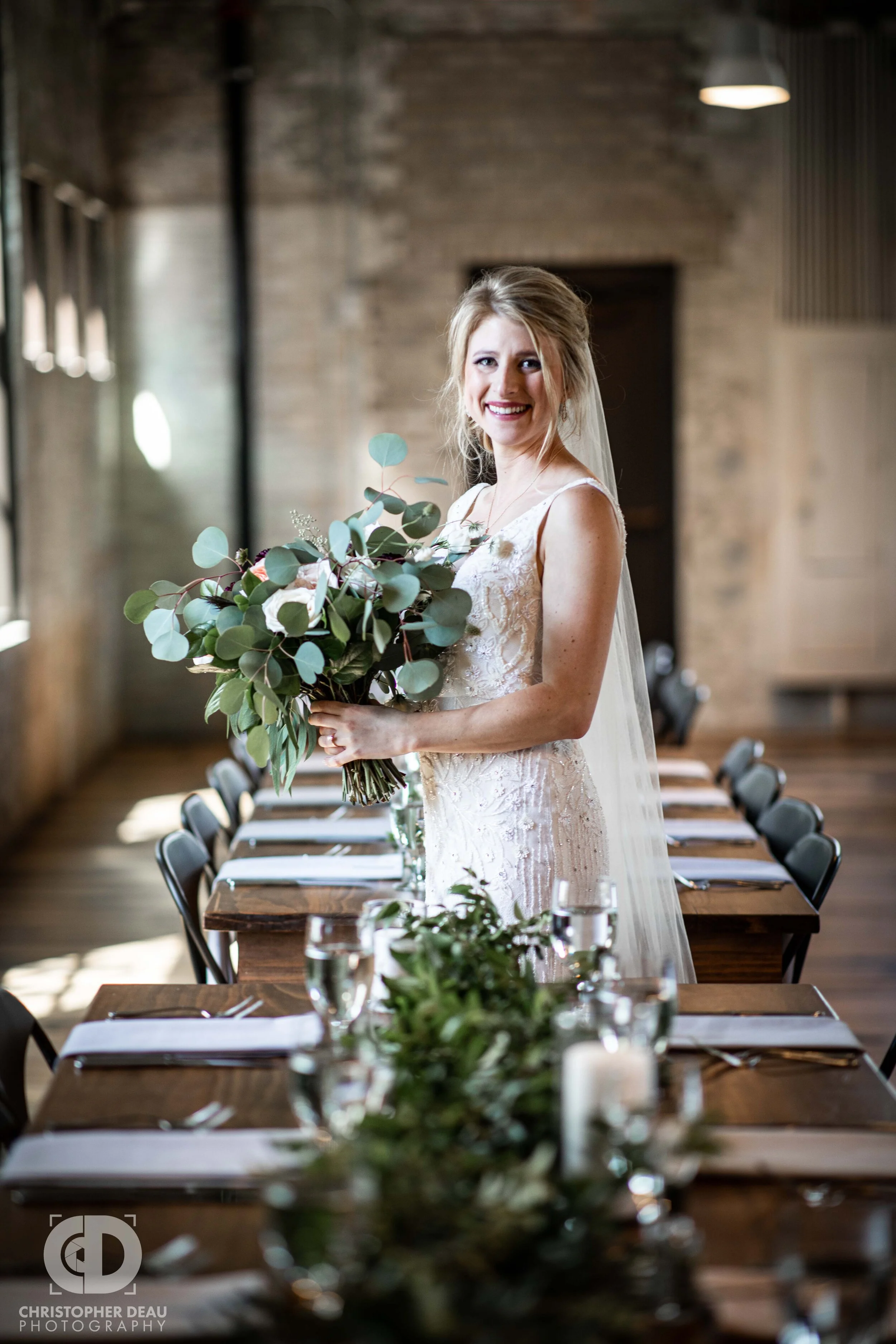 bride posing with bouquet at journeyman distillery