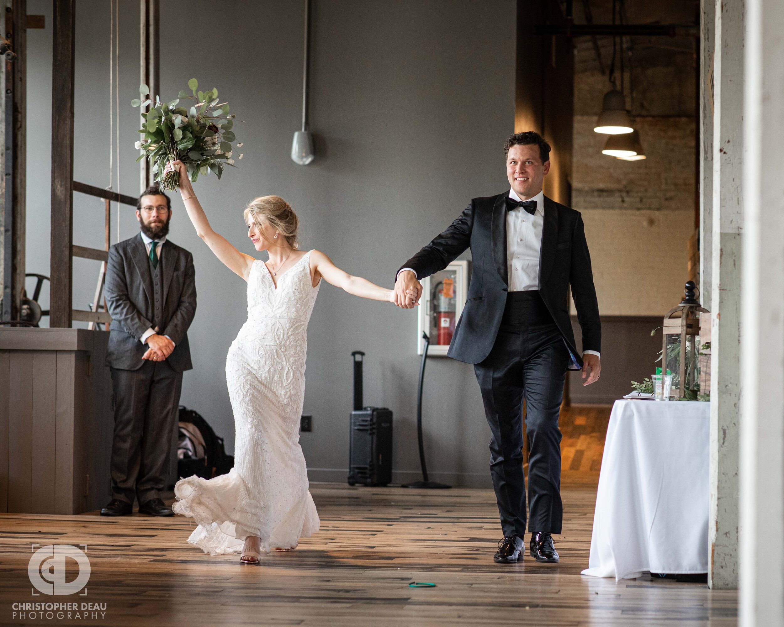  bride and groom make a grand entrance at the journeyman distillery in saint joseph michigan 