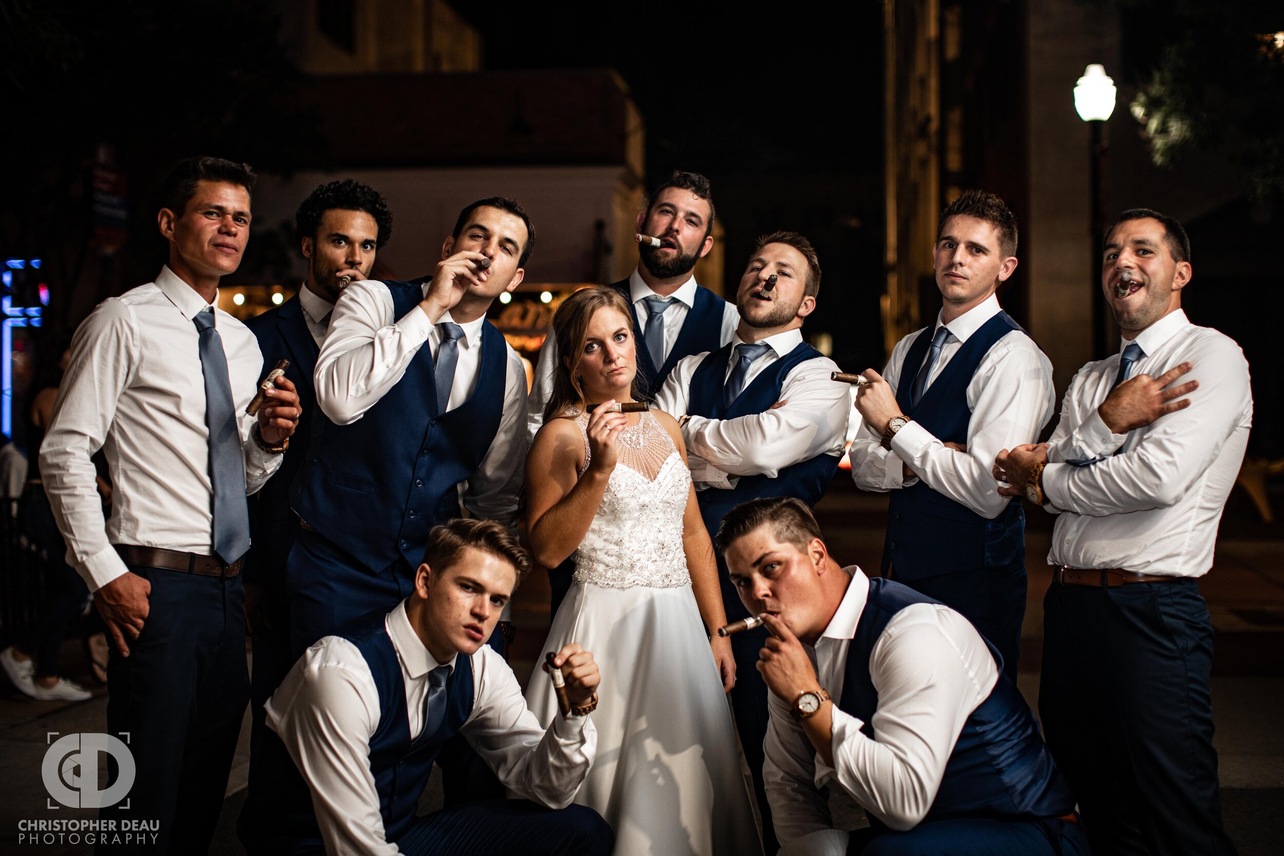  bride and groomsmen have cigars on the kalamazoo mall 