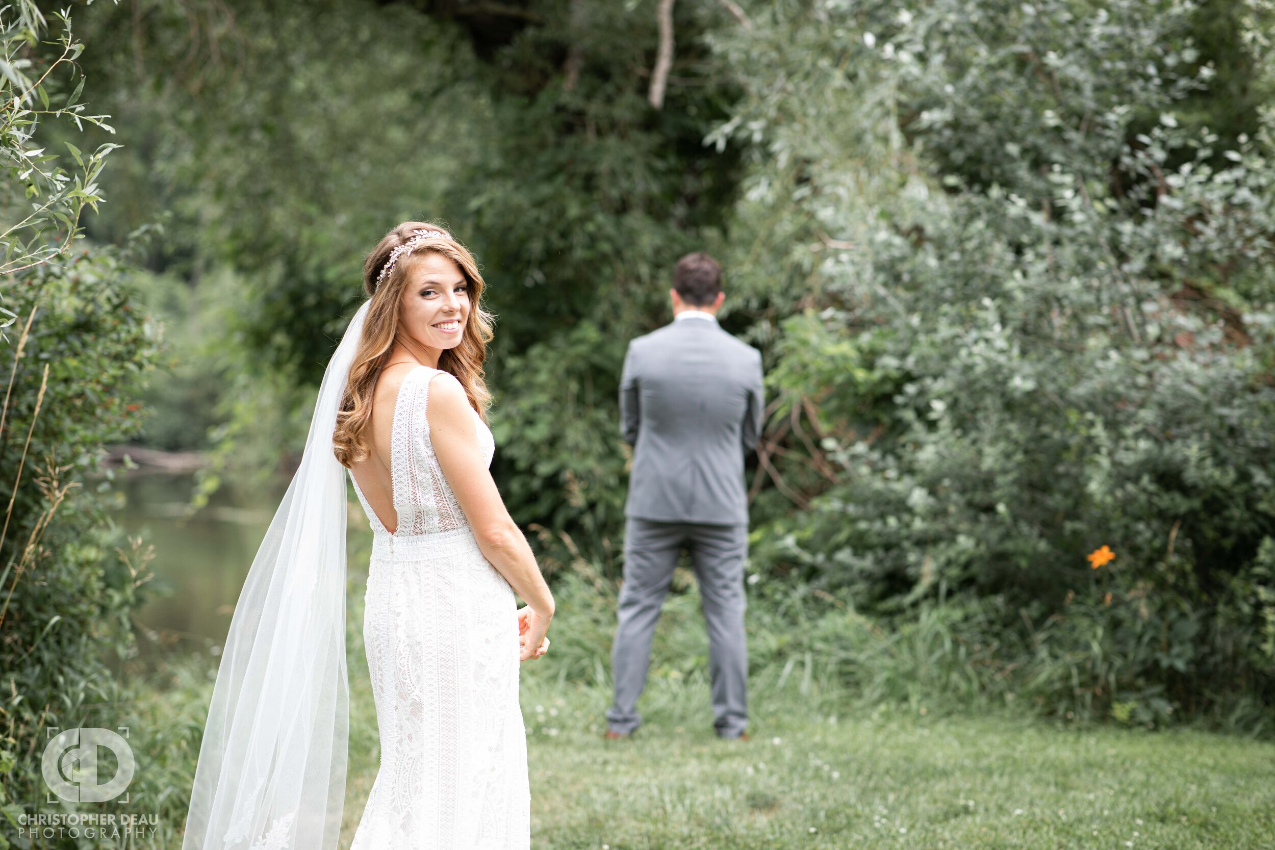  bride turns to look at the camera before seeing her groom for the first time 