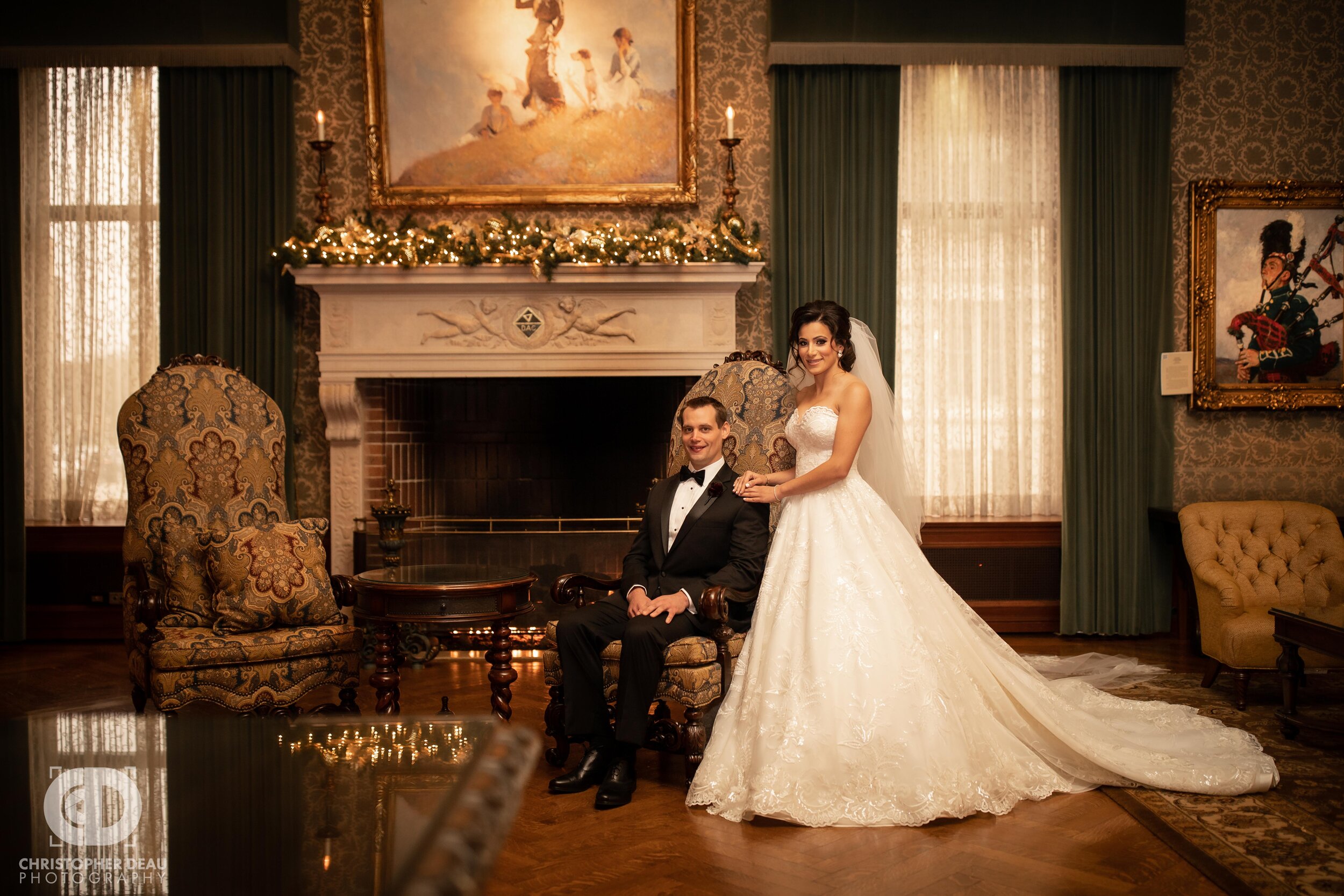  Bride and groom pose for a photo in front of a fire place at the Detroit Athletic Club 