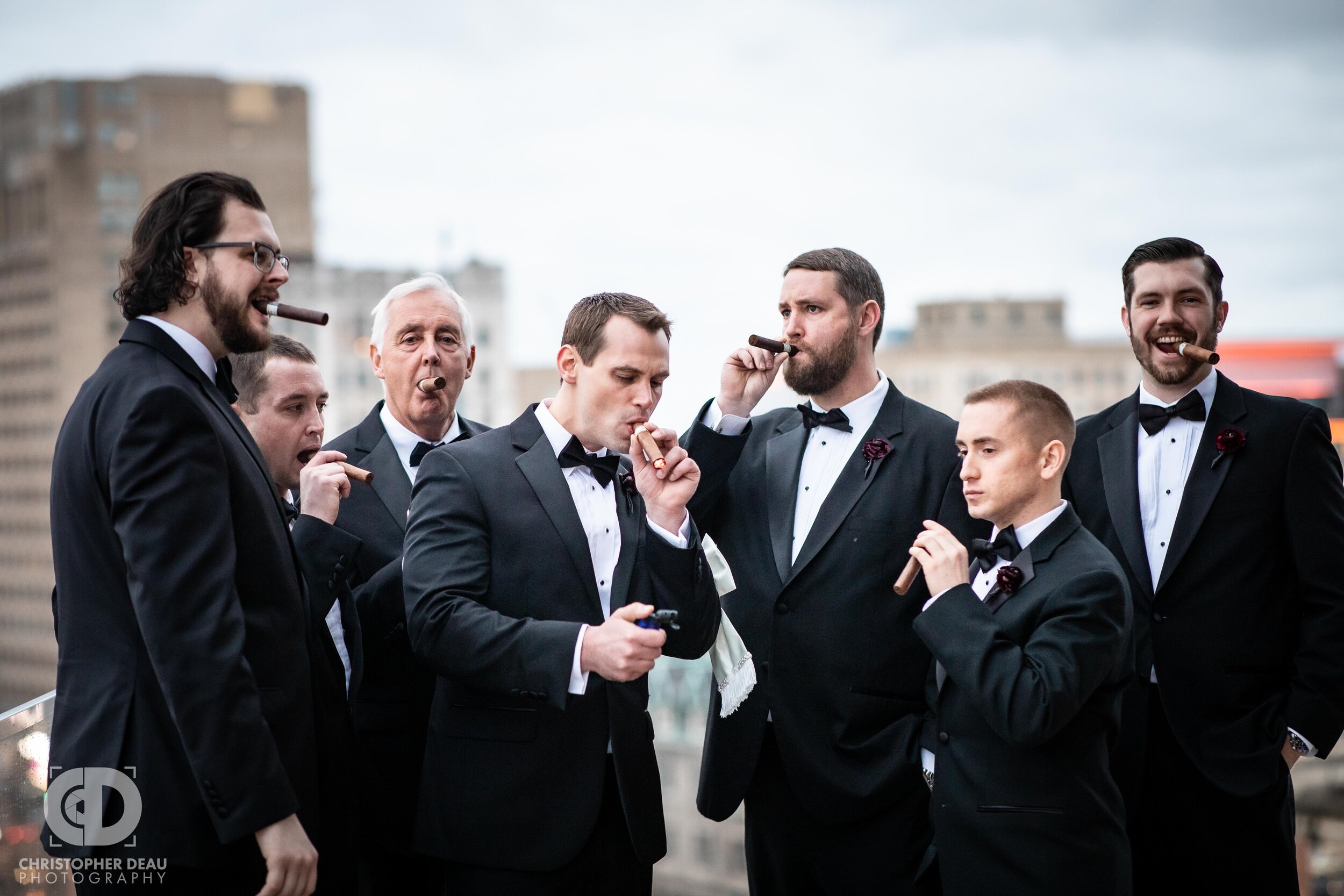  The groom and groomsmen enjoying cigars on the rooftop of the Detroit Athletic Club 